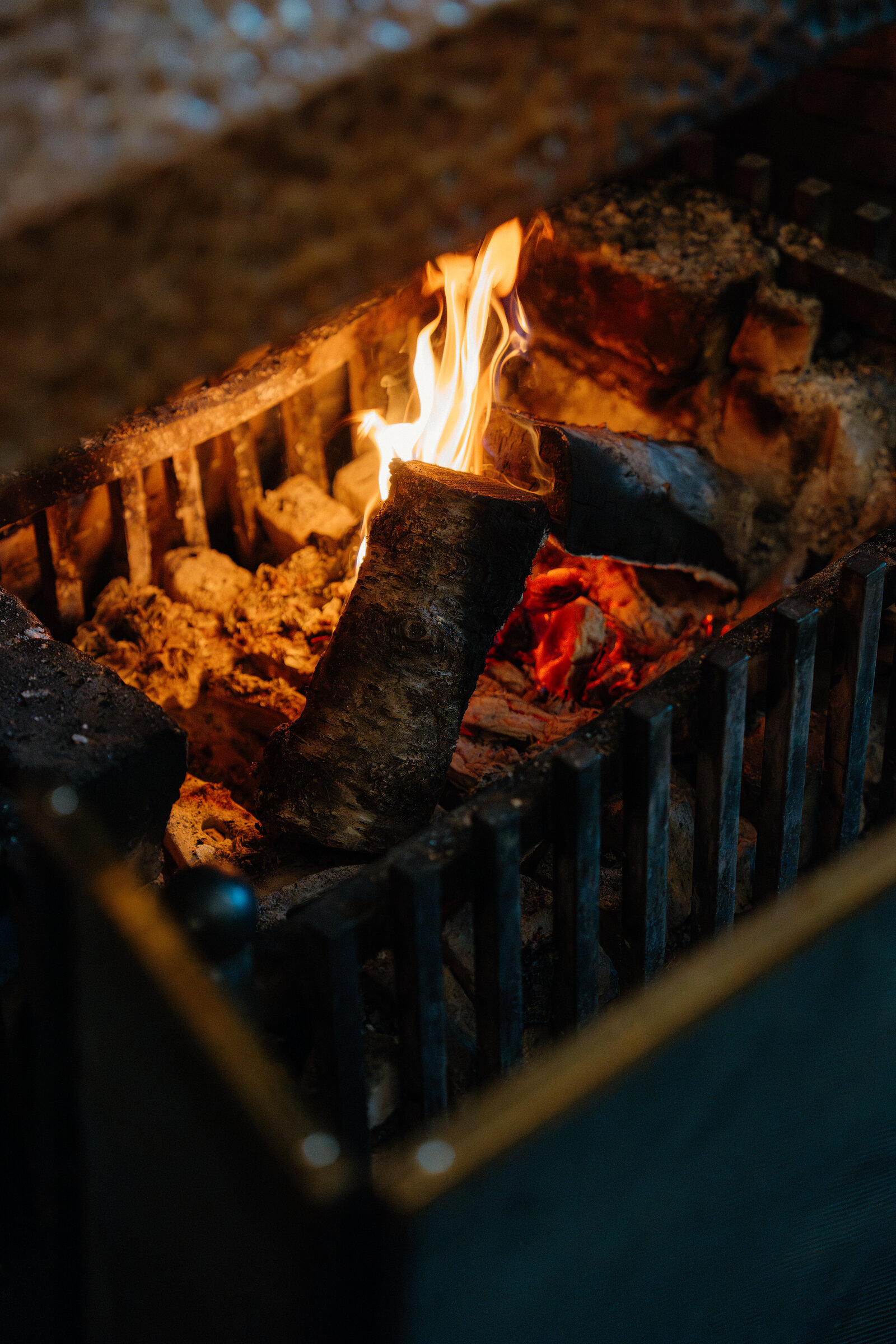 Flames burn in a wood-burning stove's grate at Skeabost.