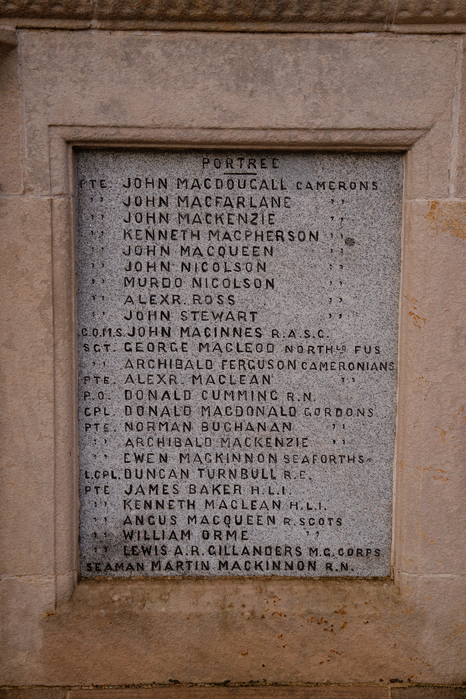 A stone war memorial panel lists 'Portree' servicemen's names by rank and regiment.