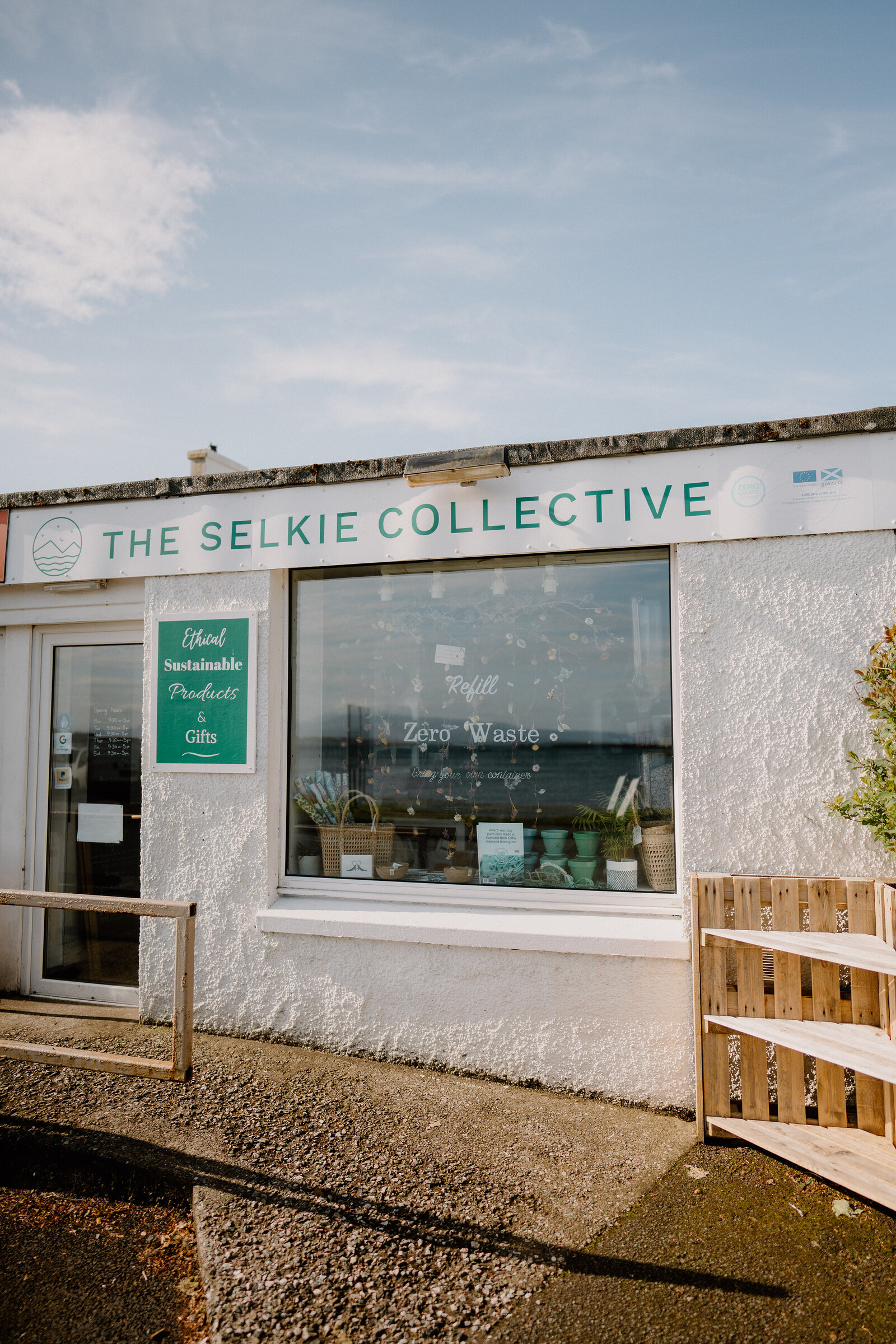 The Selkie Collective's whitewashed shopfront reads its name in green lettering above a window display of woven baskets.