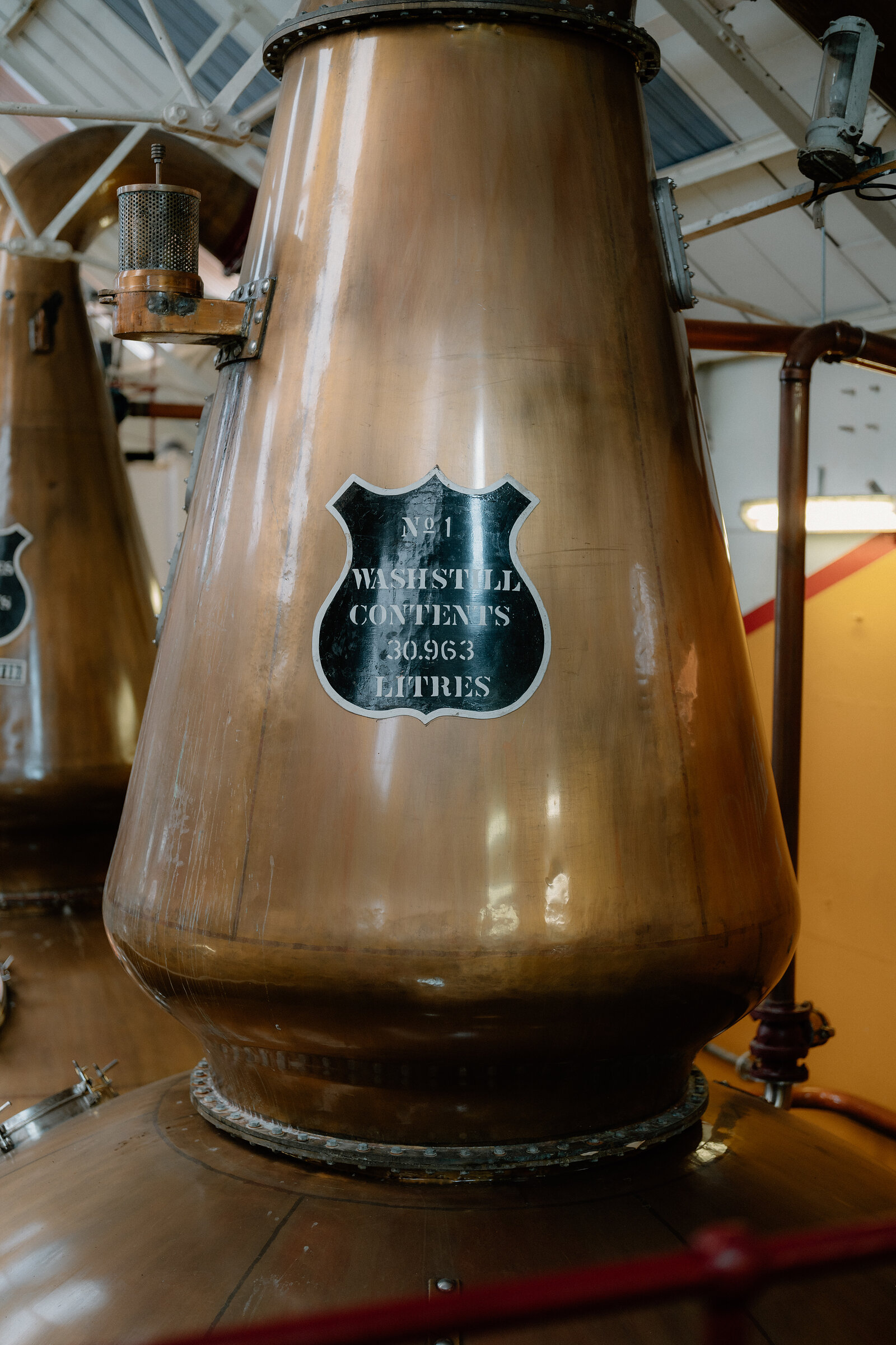 A copper wash still carries a plaque reading 'No.1 Washstill Contents 30,963 Litres' at Glenkinchie.