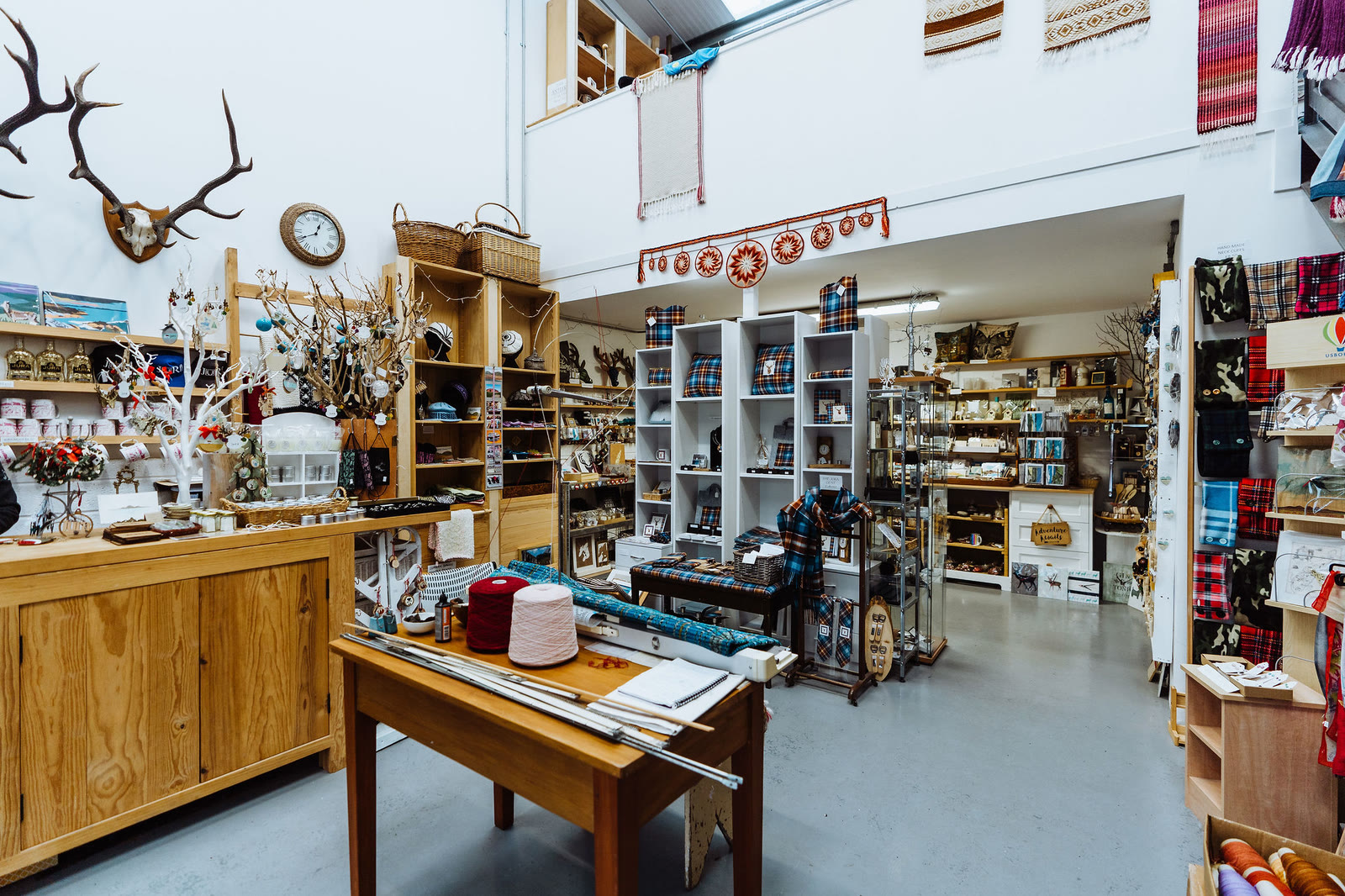 Inside Camella Crafts: antlers on the wall above shelves of island-made gifts and tartan.