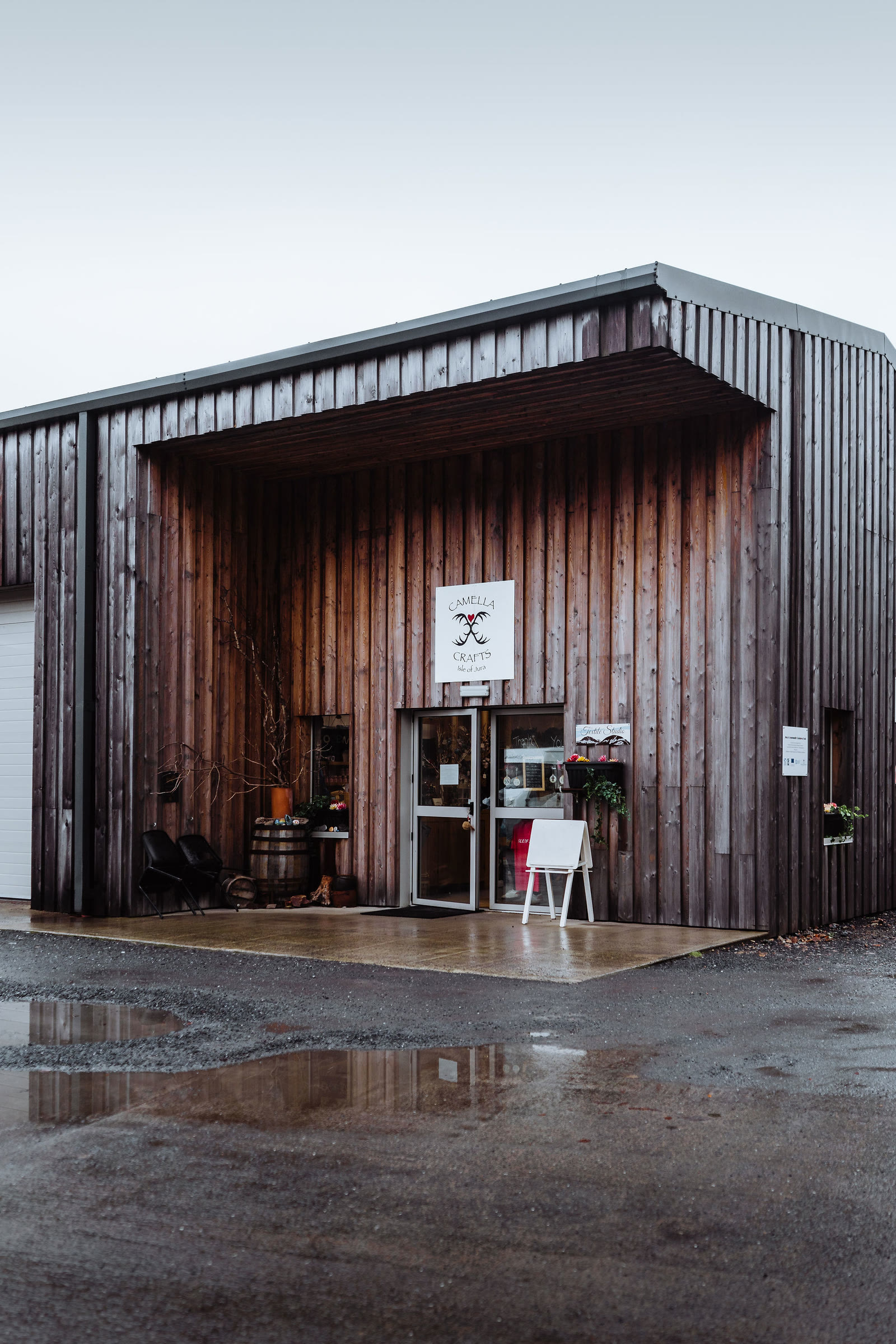 The dark timber shed of Camella Crafts at the Pier Garage, Craighouse.