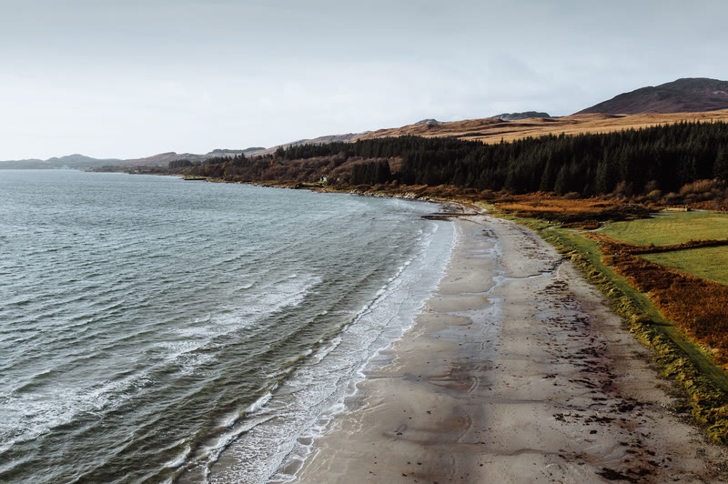 The sweep of Corran Sands and Small Isles Bay, the hills of Jura behind.