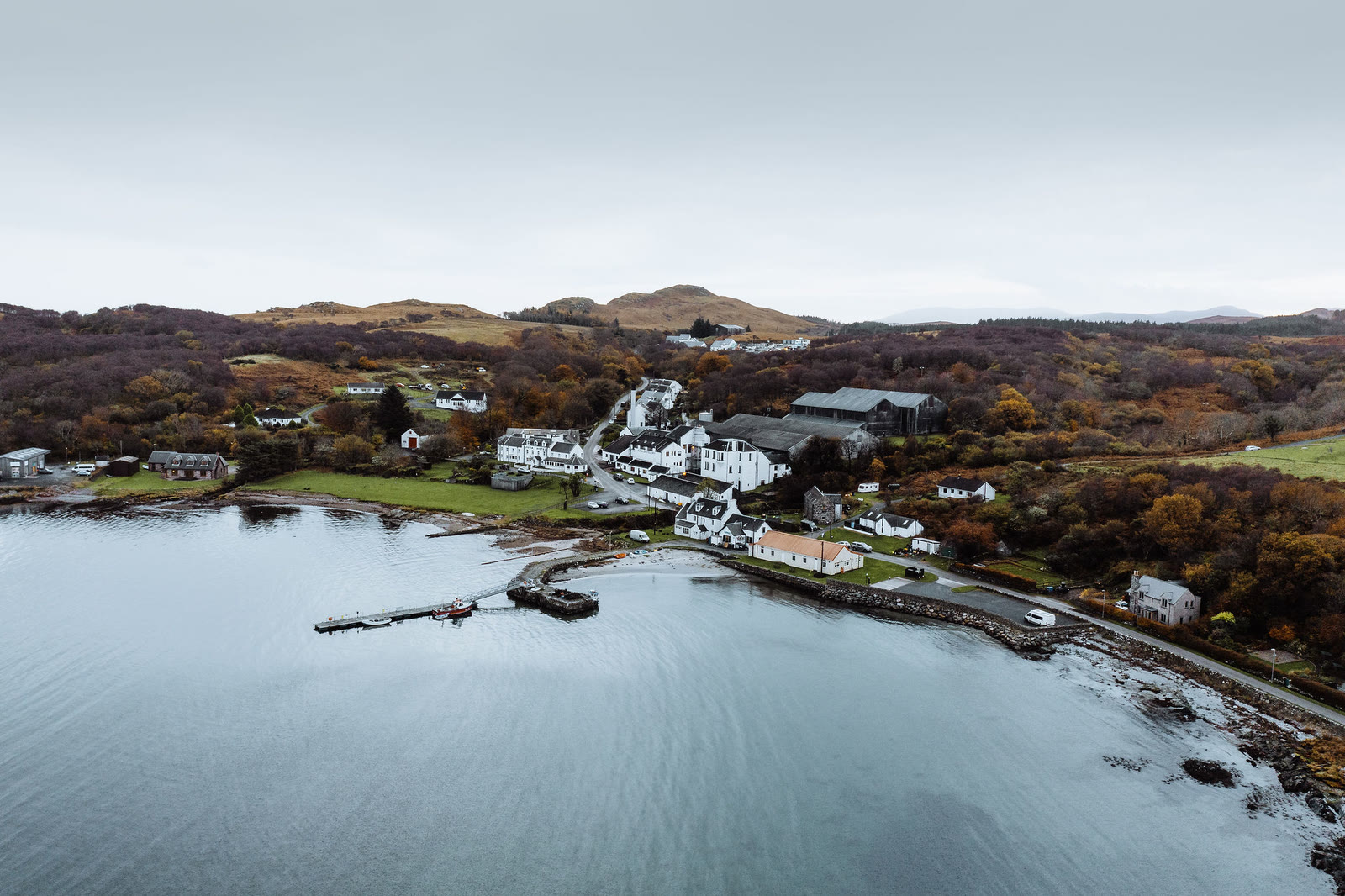 Craighouse along the shore of its bay, from the air.
