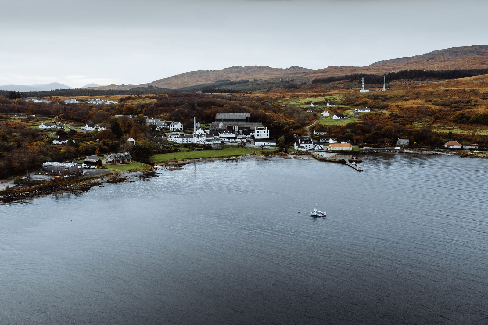 Craighouse and its bay from above, moorland hills behind.