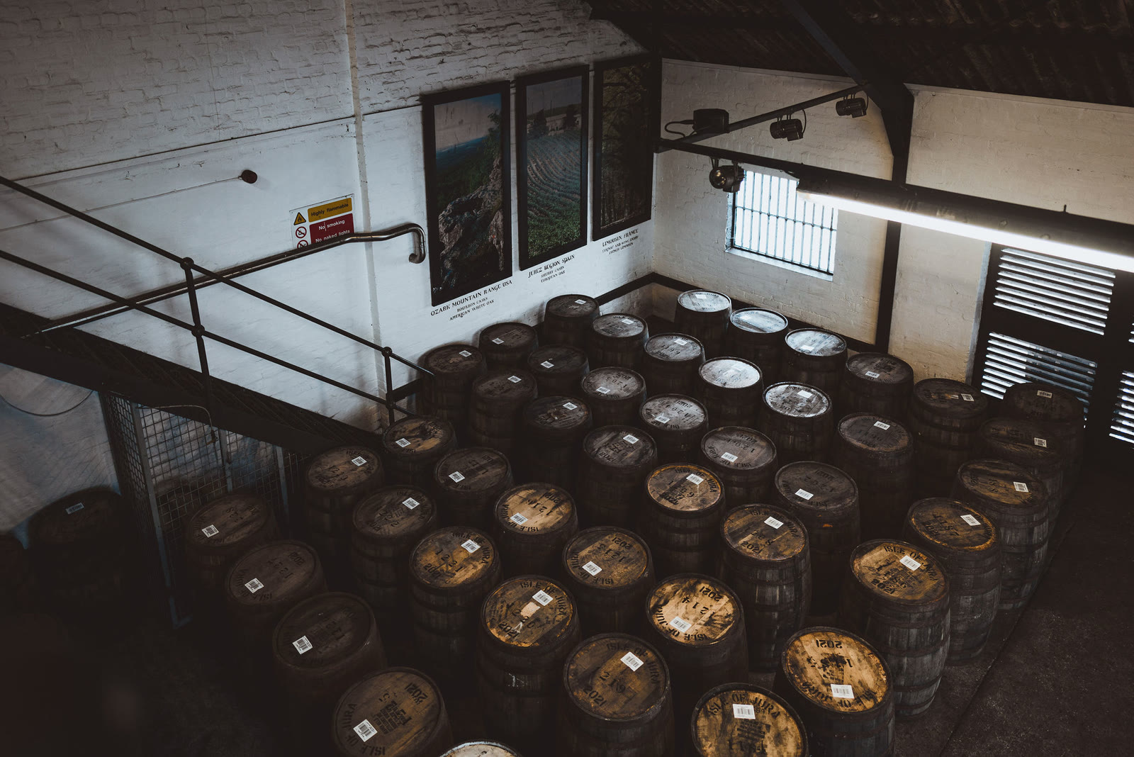 Casks standing on end in a warehouse at the Jura Distillery.