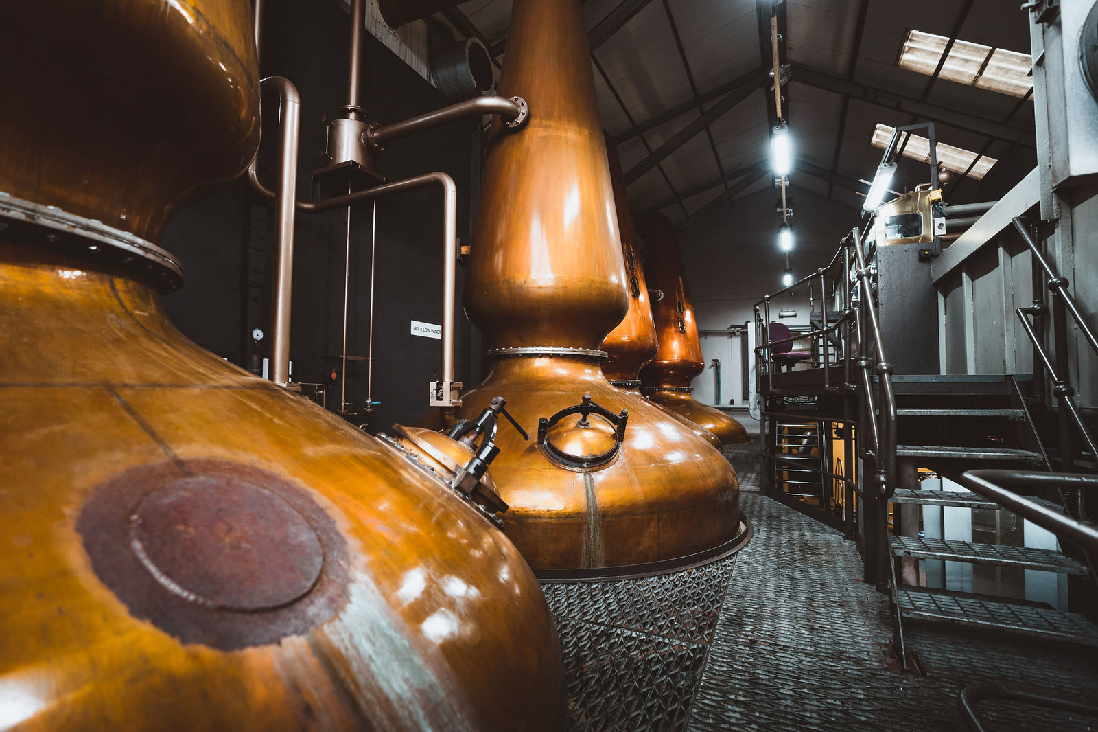 The still house at the Jura Distillery, tall copper stills in a row.