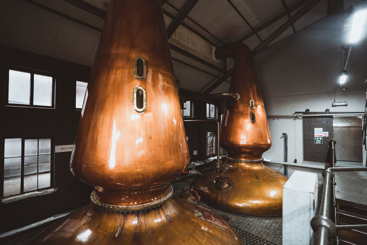 Two tall stills by the still house windows.