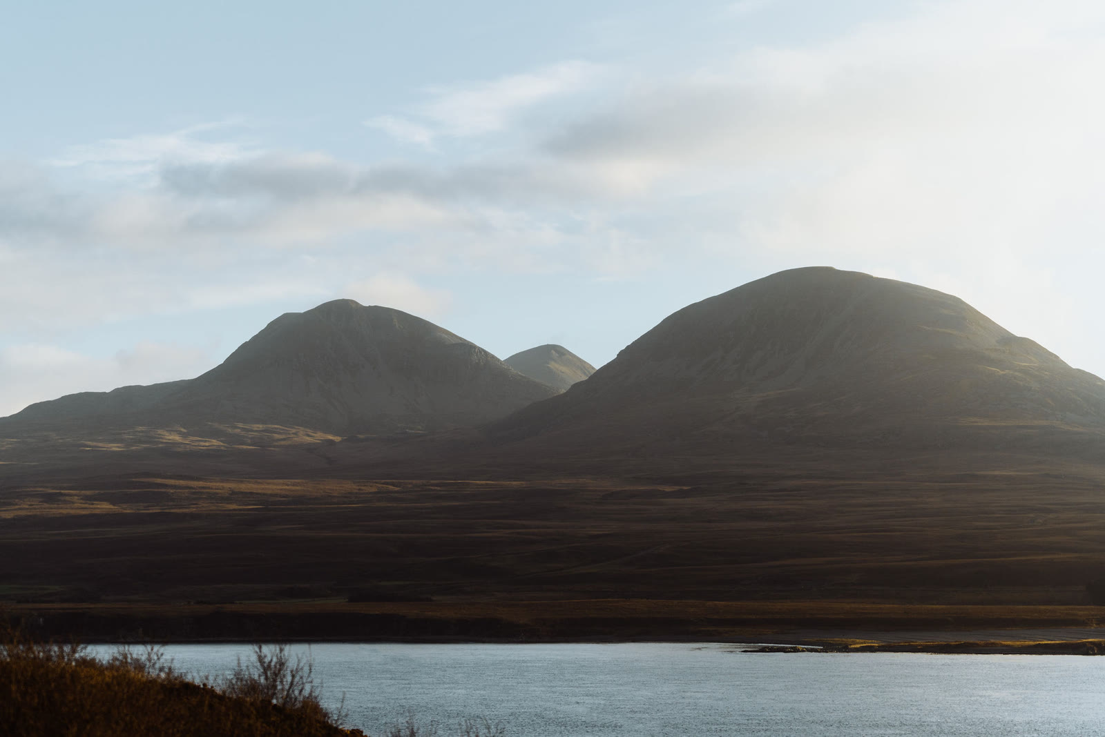 The Paps of Jura, two rounded hills side by side, above moorland and the Sound of Islay.