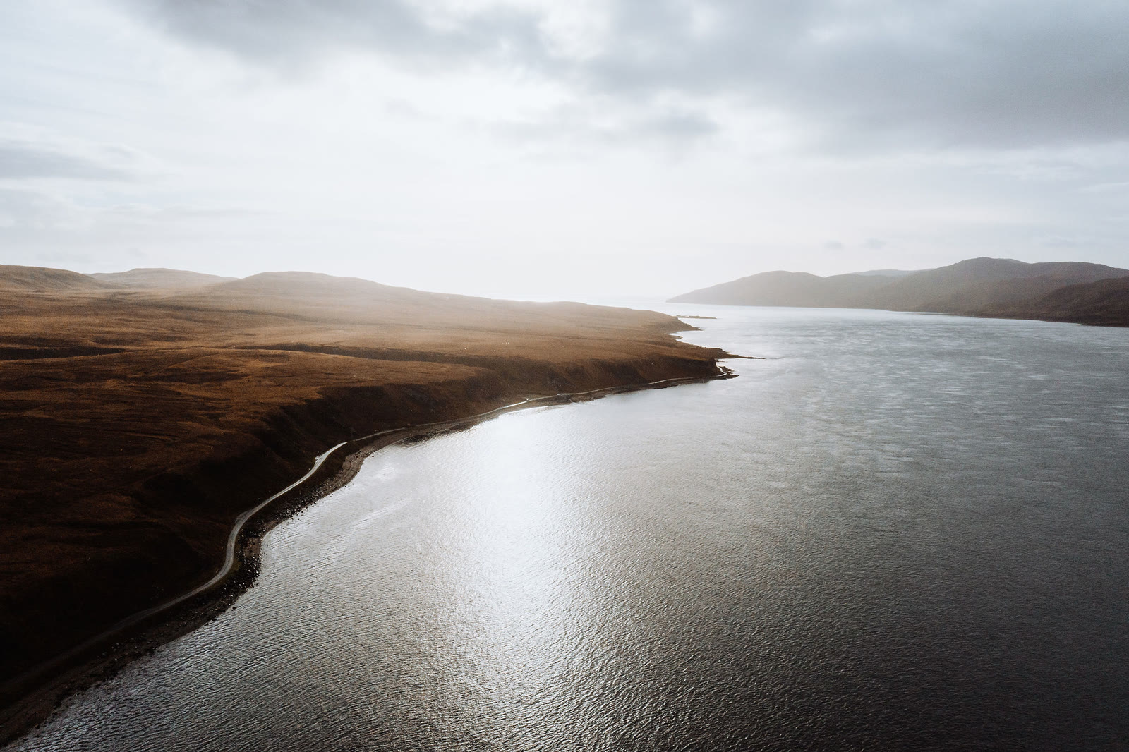 Sunlight on the Sound of Islay beside Jura's shore road, from the air.