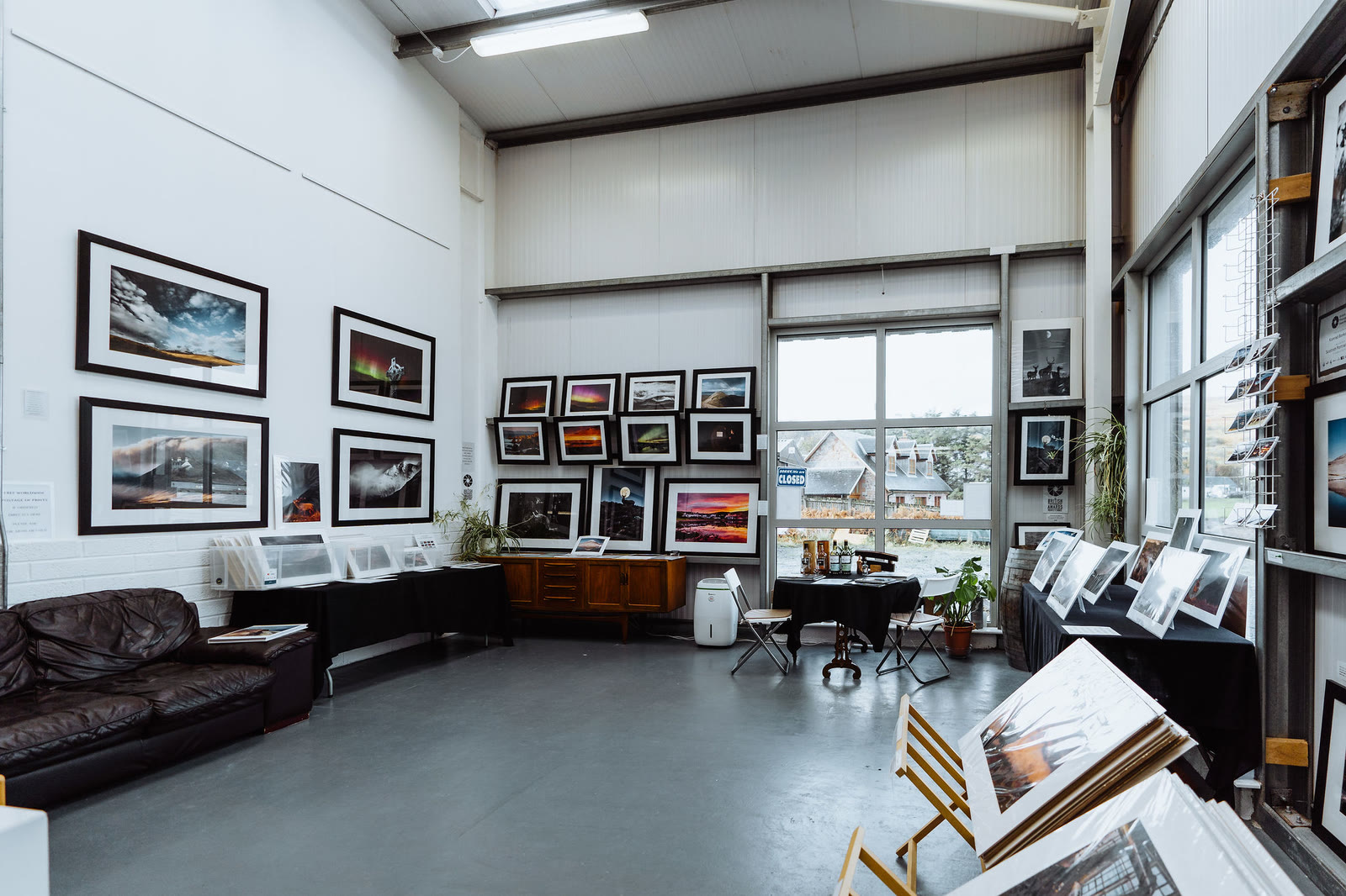 Framed landscape prints on the white walls of the Whisky Island Gallery.