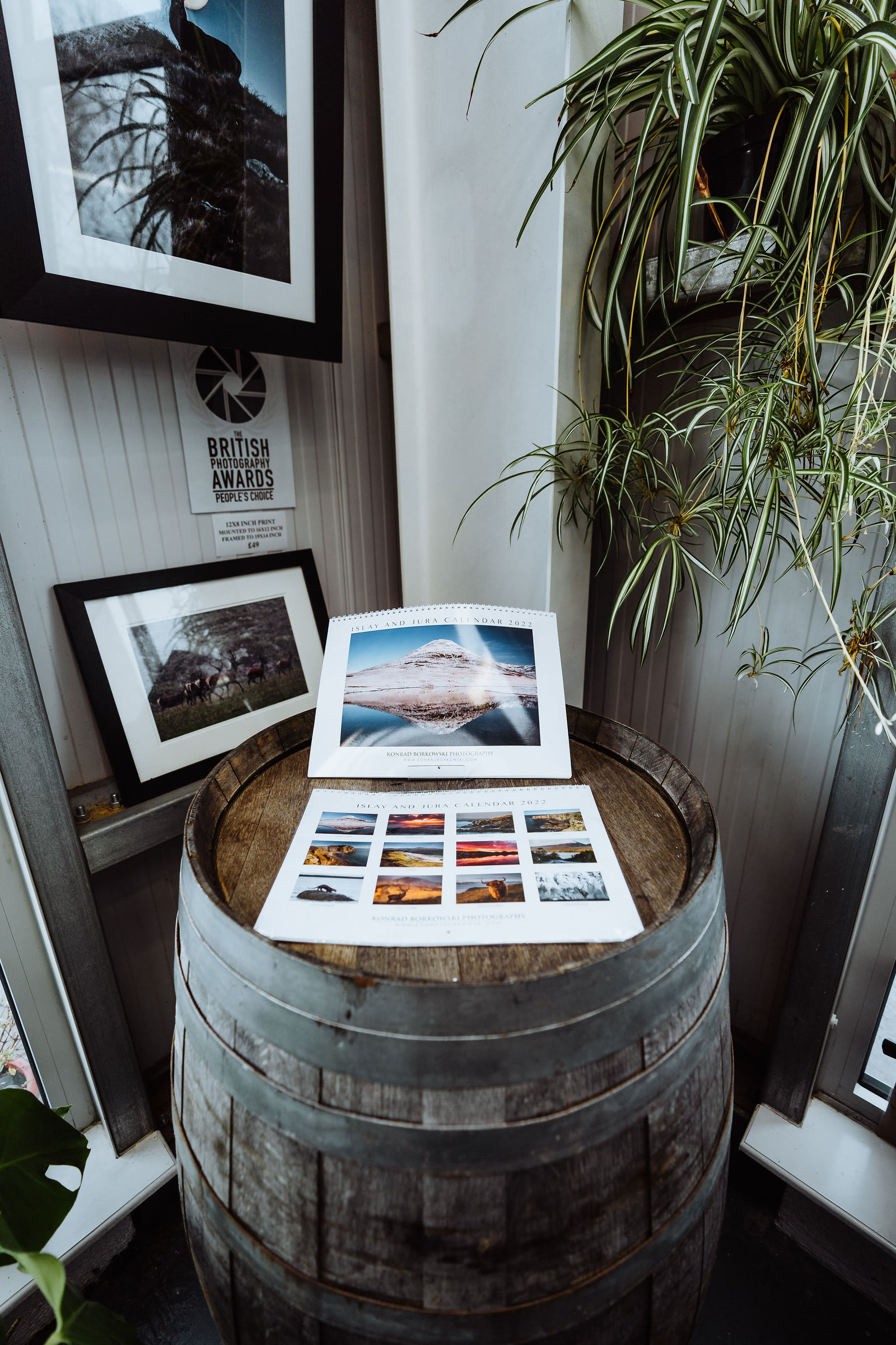 A whisky cask used as a stand for prints in the gallery.