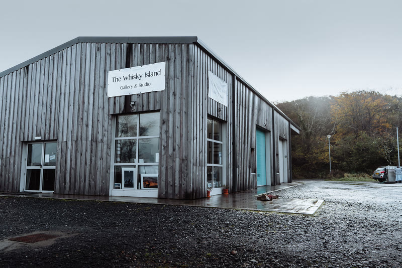 The dark timber Whisky Island Gallery and Studio at the Pier Garage, Craighouse.