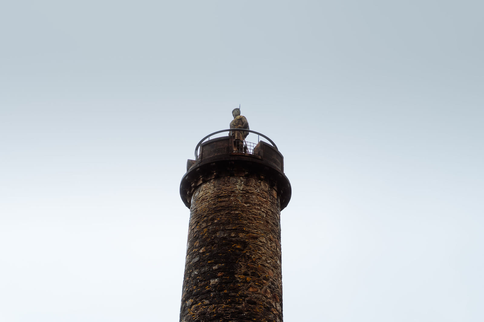 The stone Highlander on top of the Glenfinnan Monument.