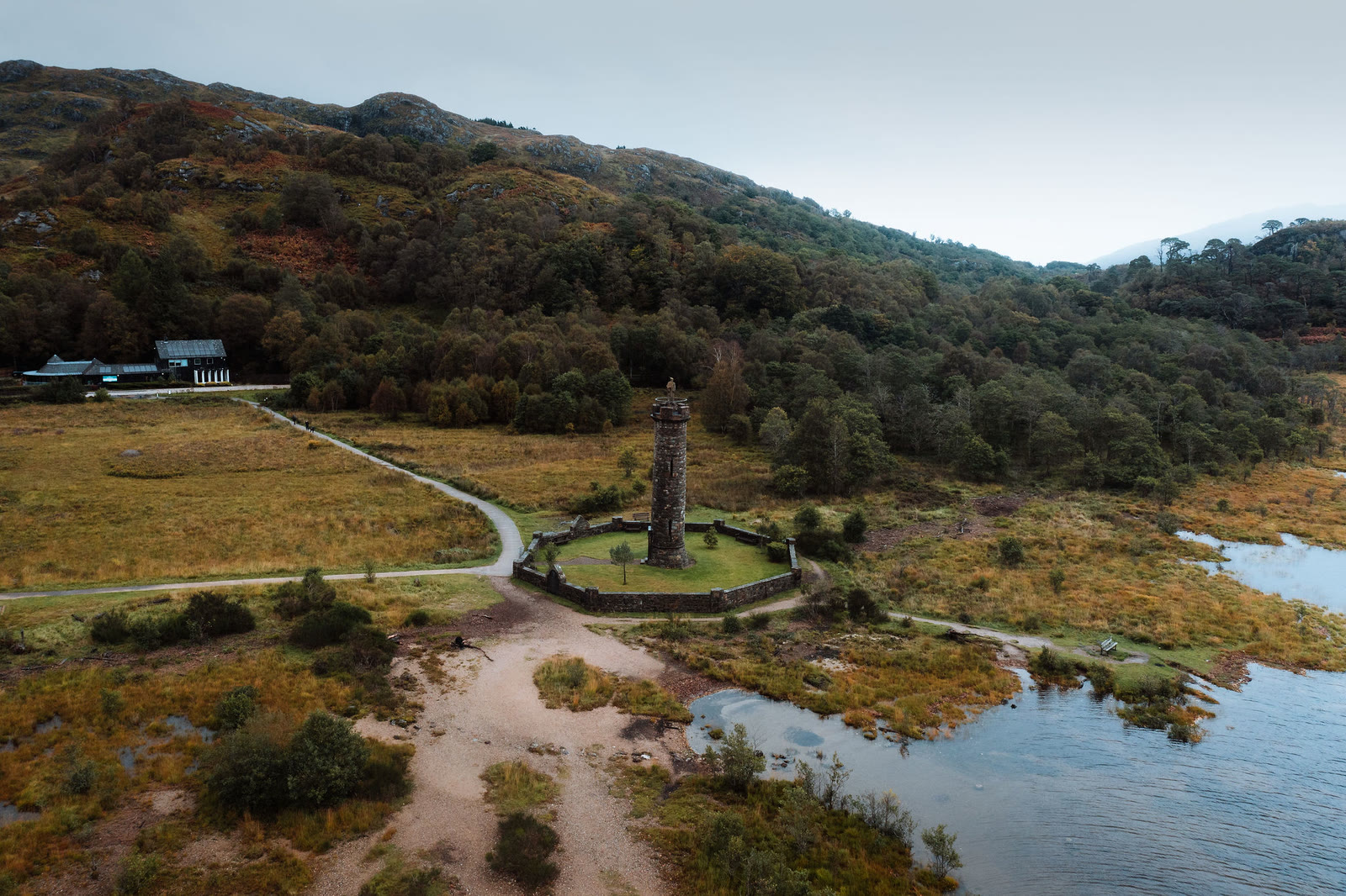 The Glenfinnan Monument from the air, its tower in a walled ring at the head of Loch Shiel.