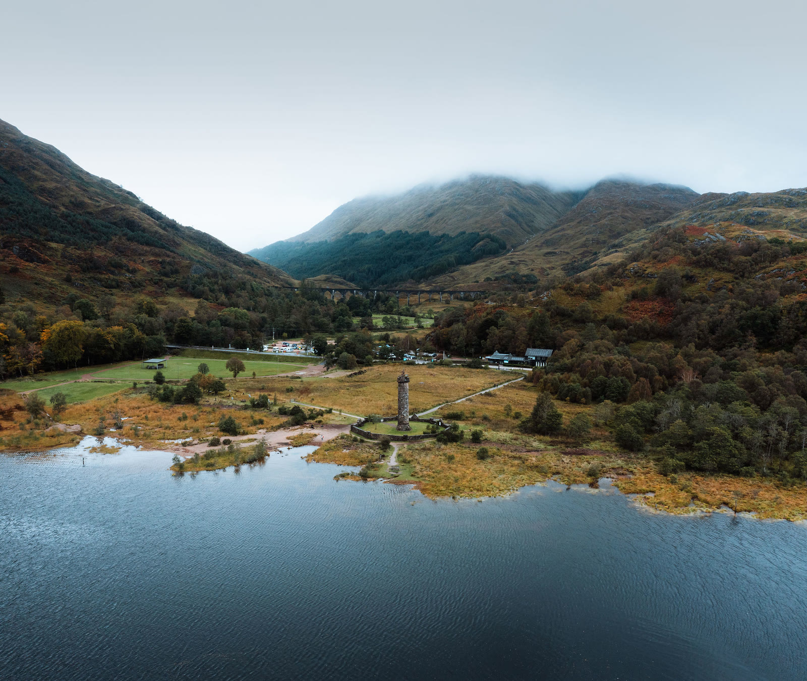 The Glenfinnan Monument and the head of Loch Shiel from the air, hills in cloud behind.