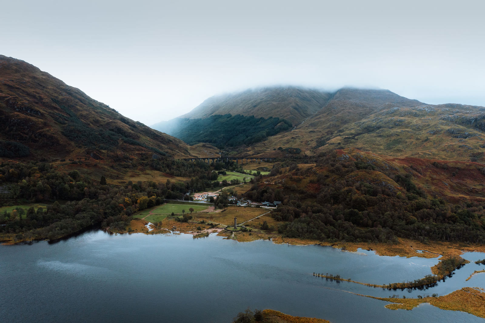 The head of Loch Shiel at Glenfinnan from the air, autumn colour on the hills.