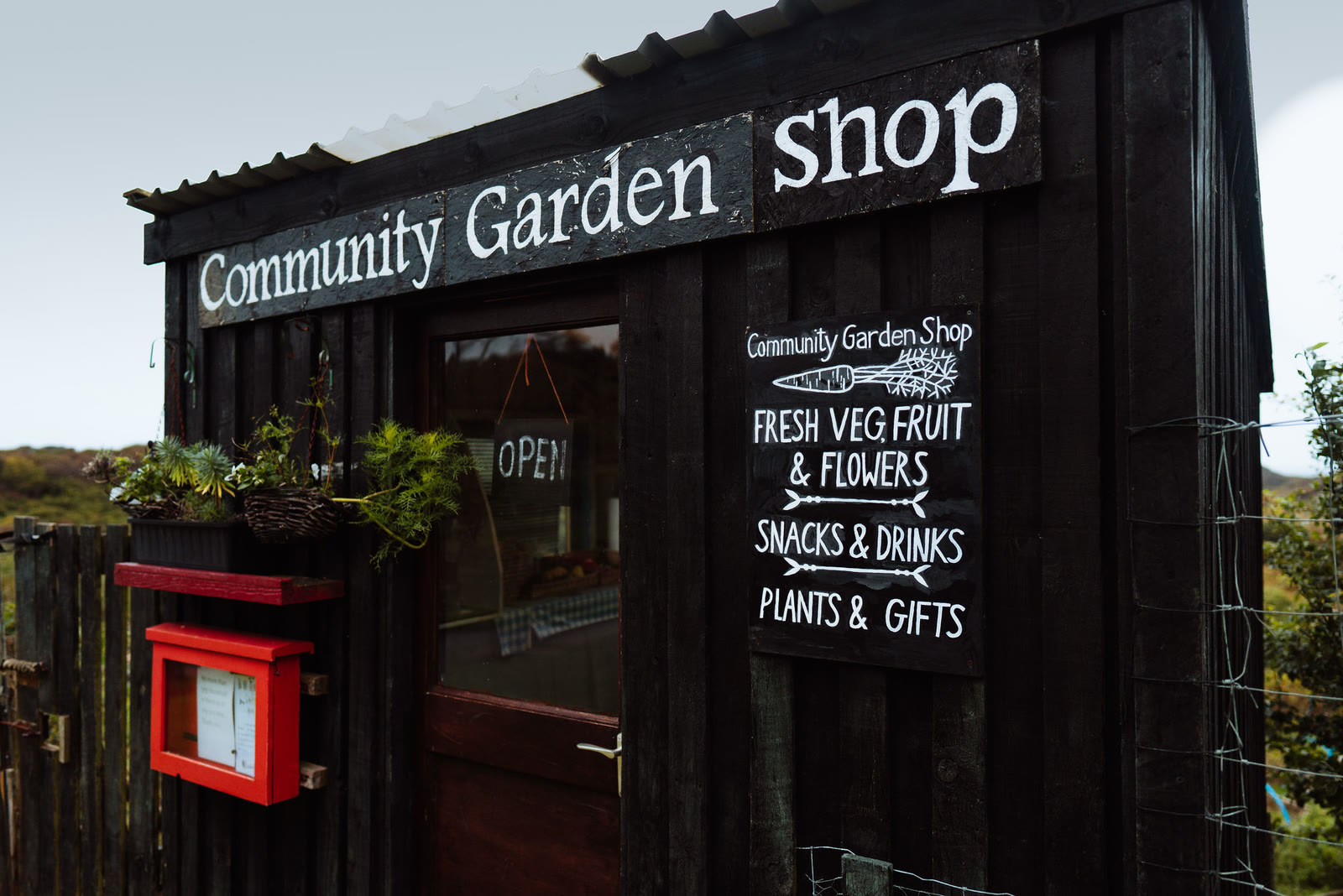 The Community Garden Shop at Kilchoan, its sign offering fresh veg, fruit and flowers.