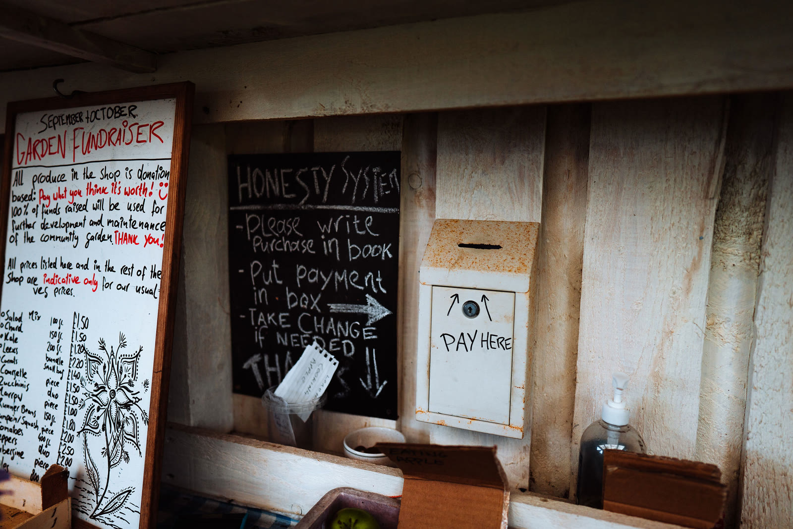 The honesty box and price list in the Community Garden Shop at Kilchoan.