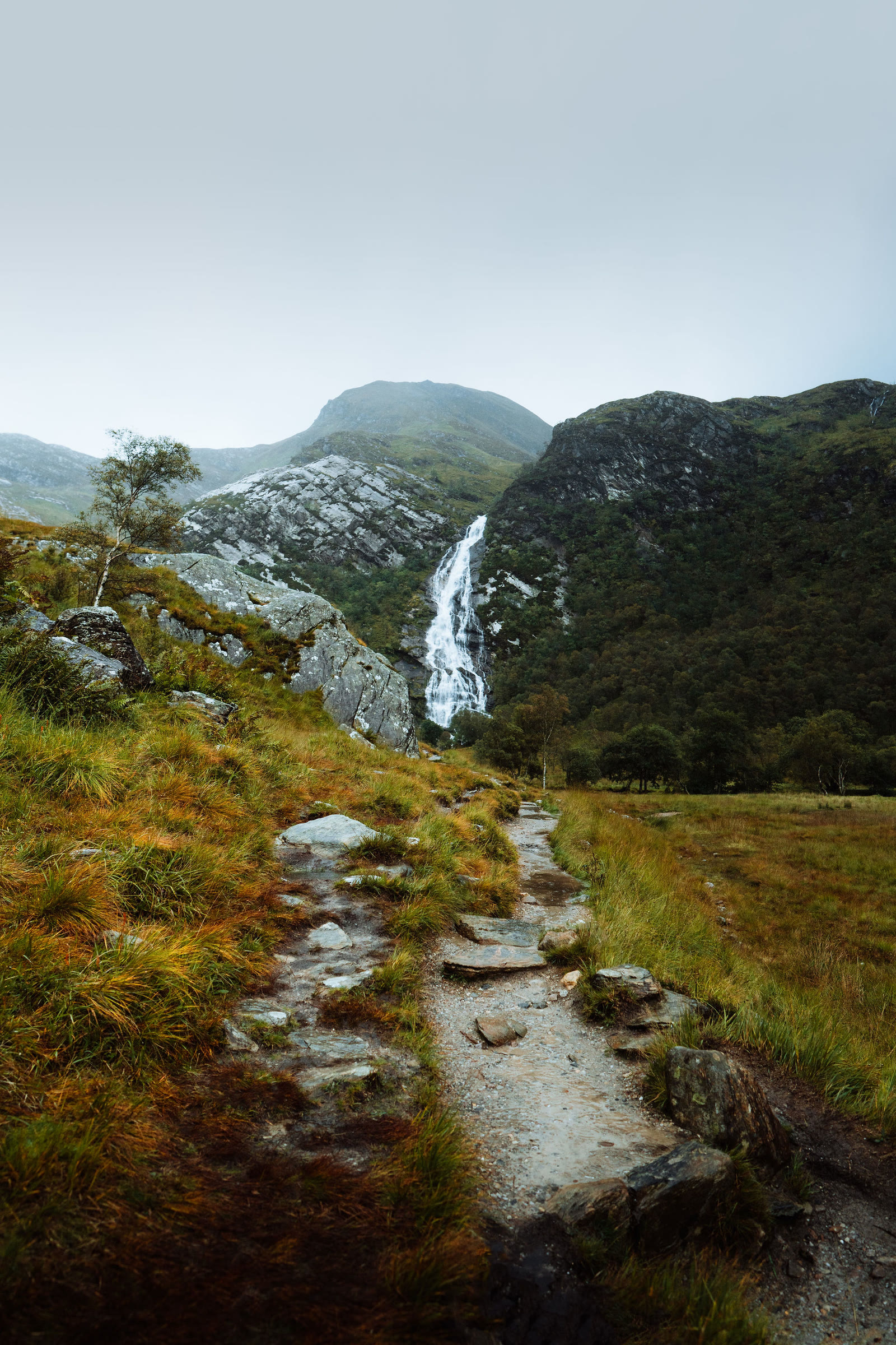A stony path through autumn grass leading to Steall Falls in Glen Nevis.