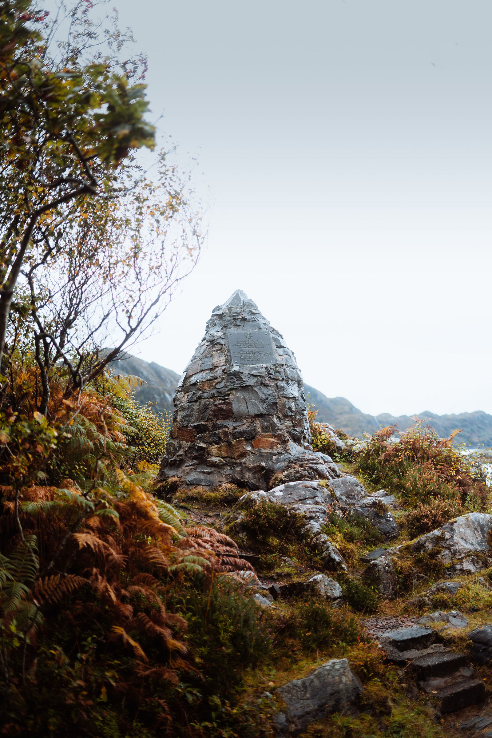 The Prince's Cairn on the shore of Loch nan Uamh, bracken turning round it.
