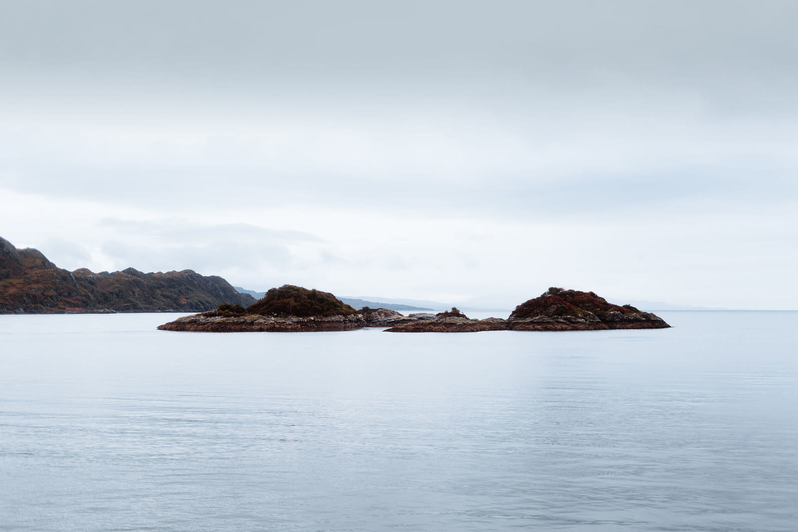 Rocky islets in the still water of Loch nan Uamh, from the Prince's Cairn.