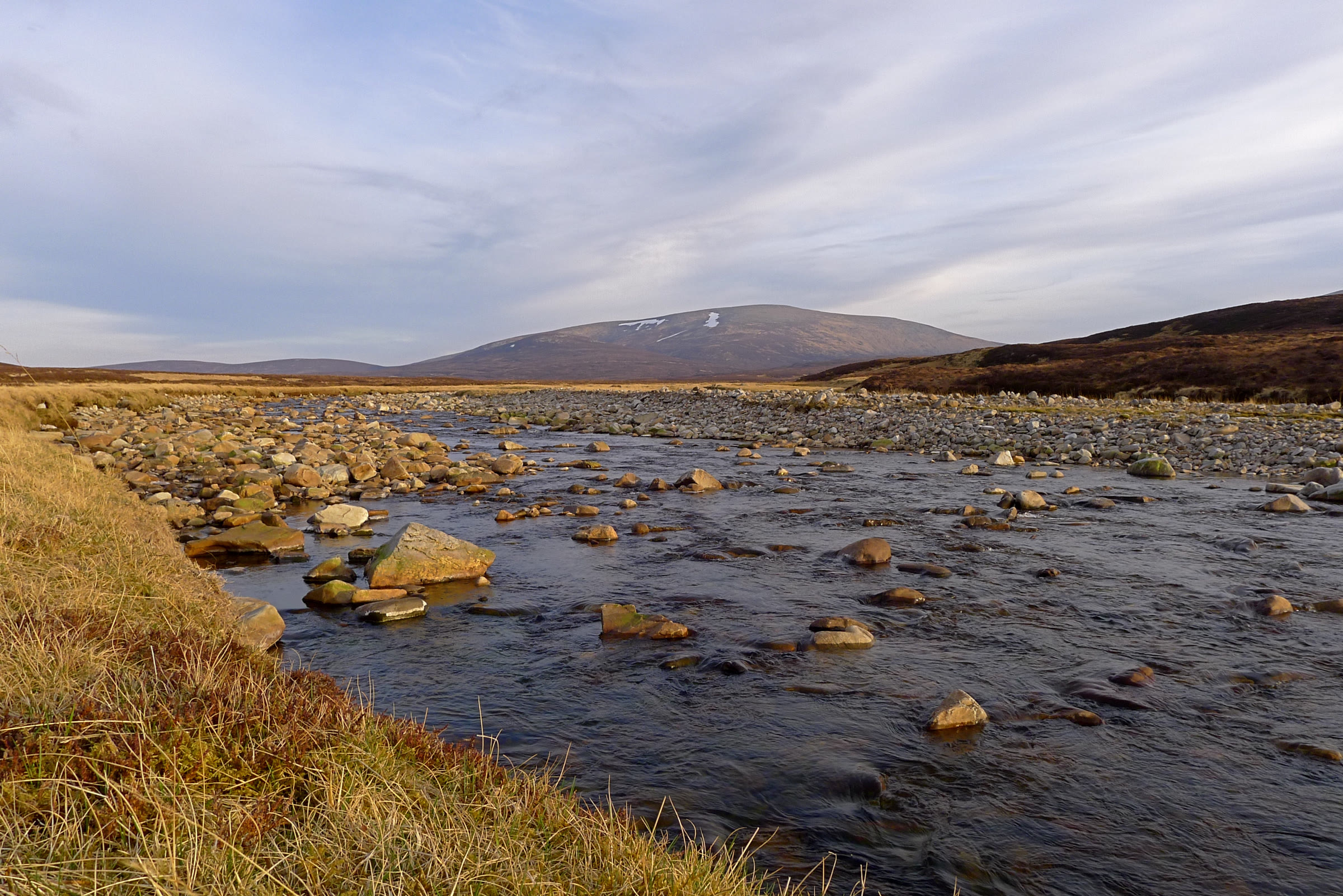 An Sgarsoch on the skyline beyond the stony bed of the River Feshie.