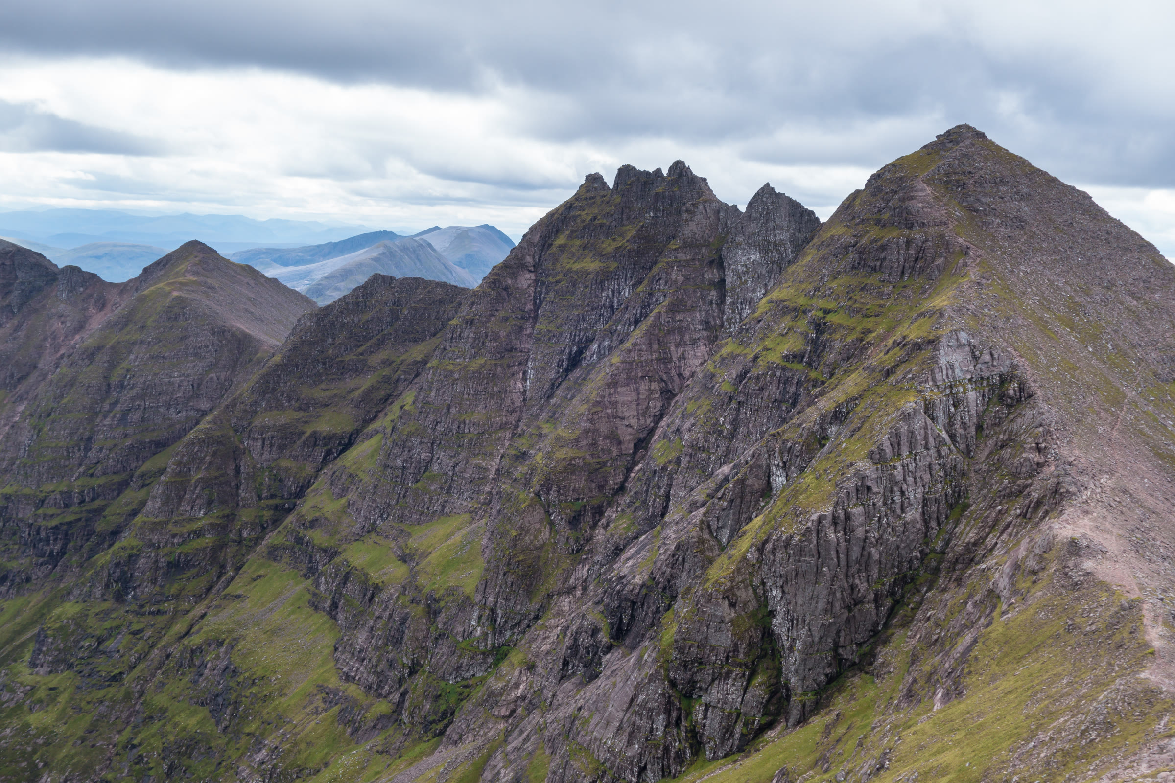 The pinnacled ridge of An Teallach, rock falling steeply into the corrie.