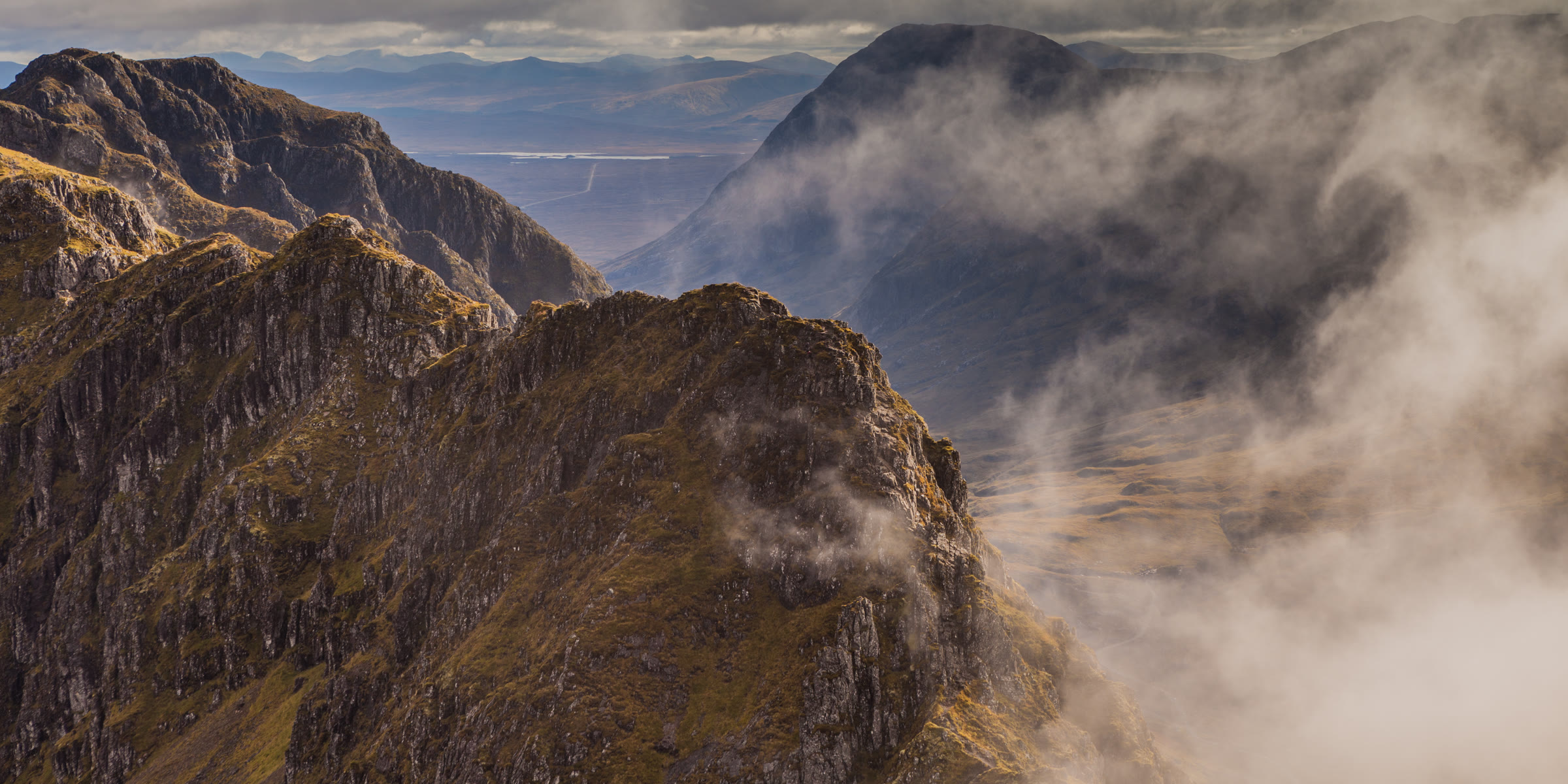 The pinnacles of the Aonach Eagach rising out of cloud.