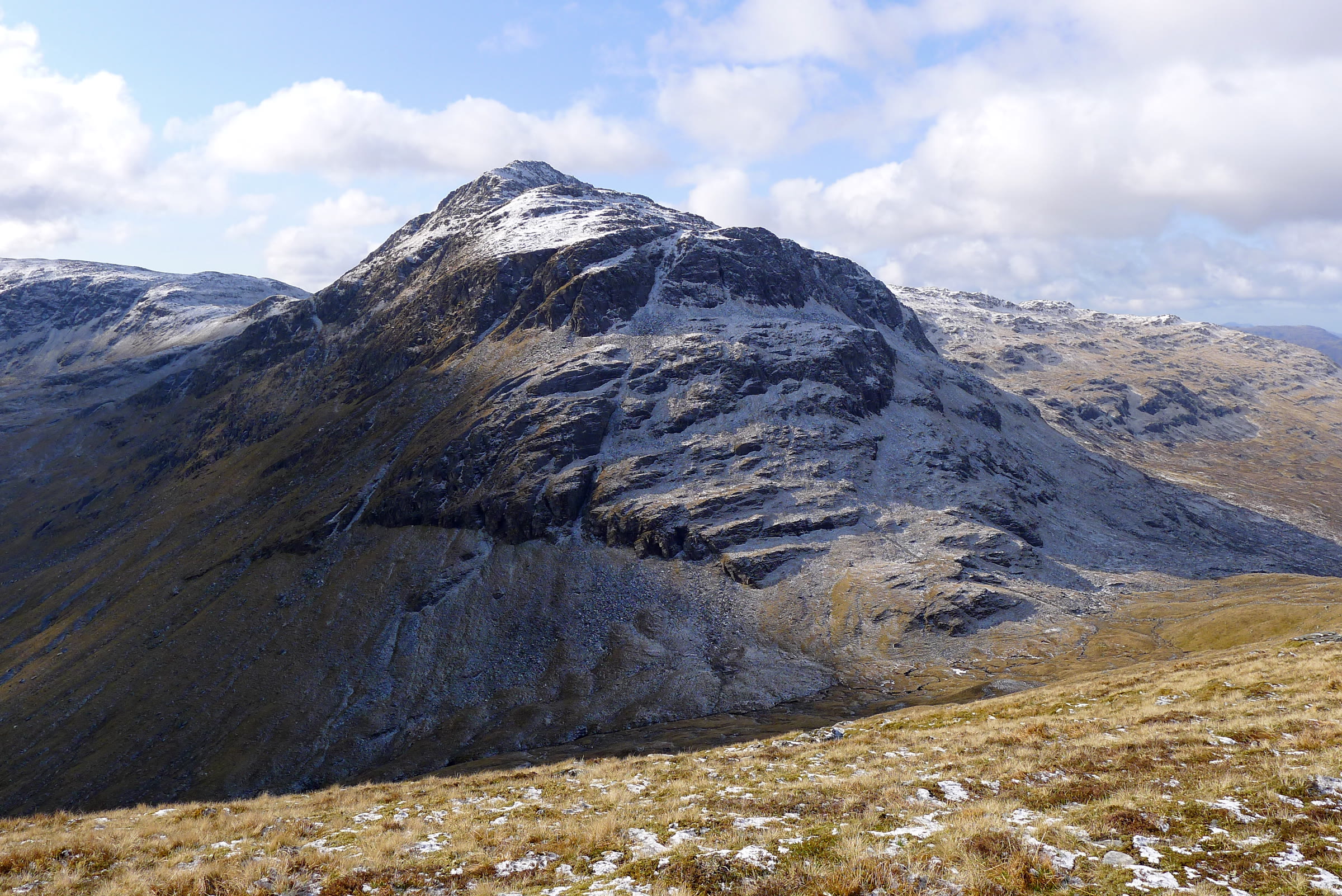 The pointed northern face of Bidein a' Choire Sheasgaich with snow on its top.