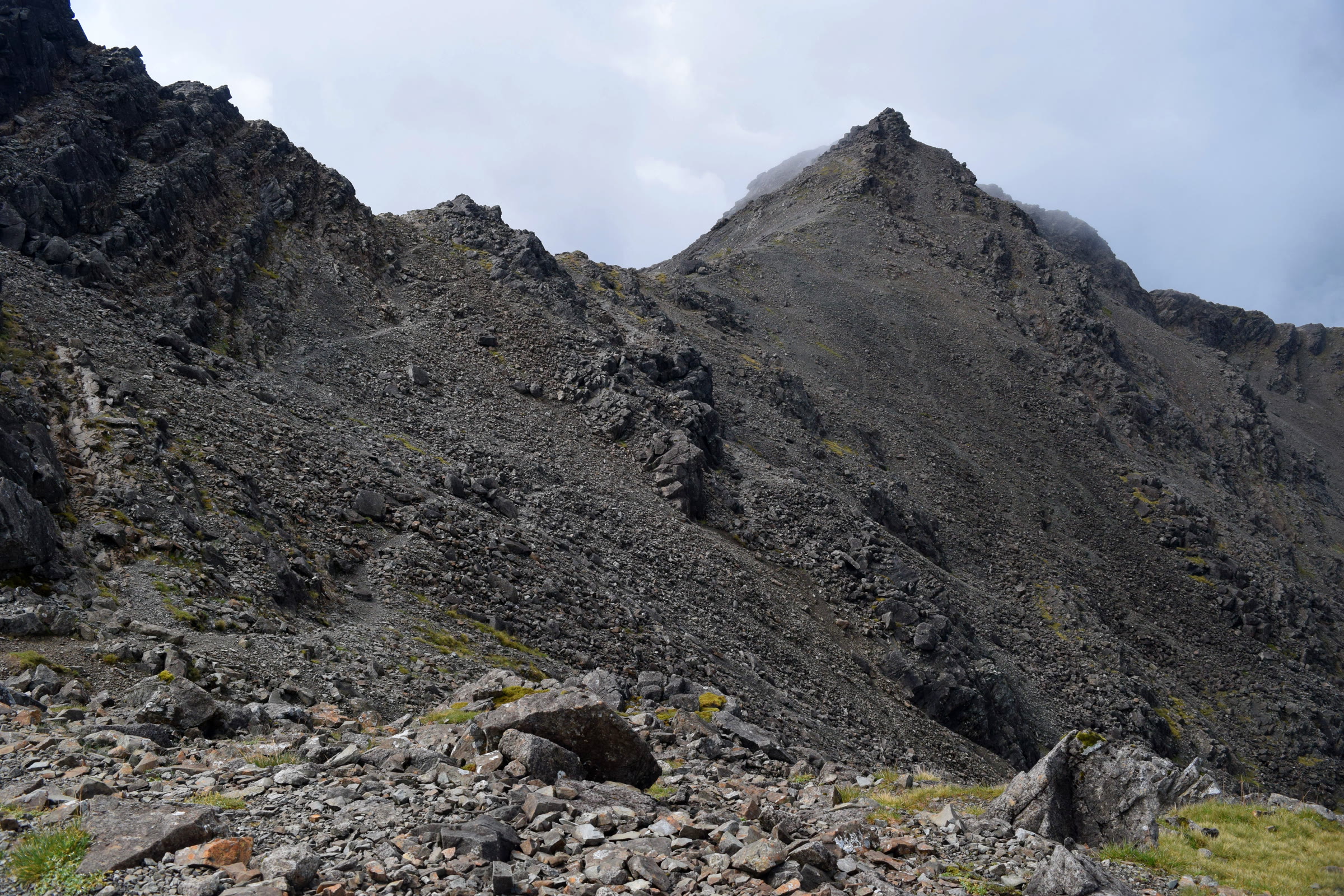 The dark rock peak of Bruach na Frìthe above scree and broken crags.