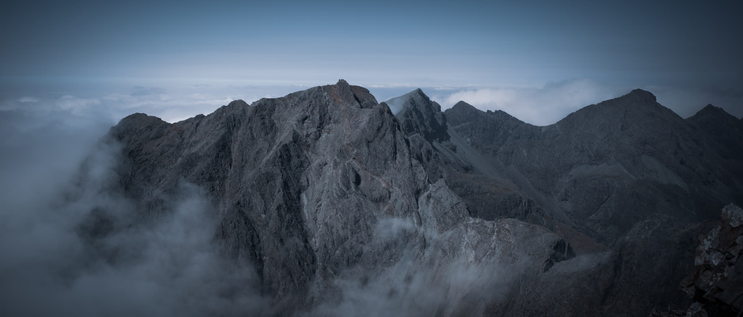The Cuillin ridge around the Inaccessible Pinnacle, dark rock above drifting cloud.