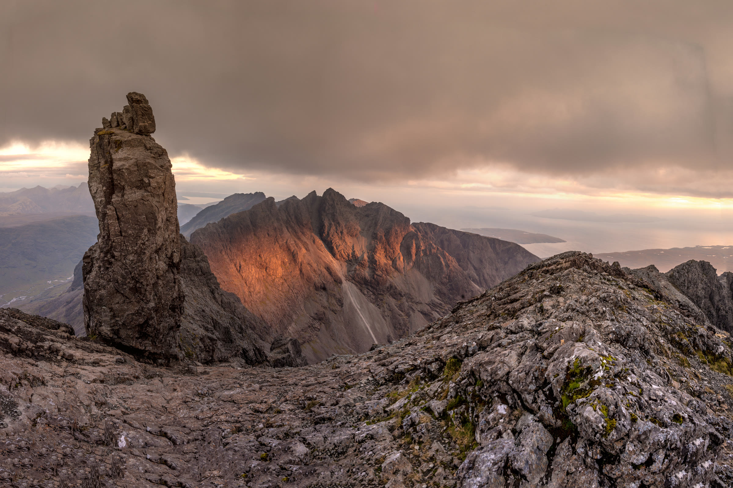 The Inaccessible Pinnacle on Sgùrr Dearg at sunset, the Cuillin ridge lit red behind it.