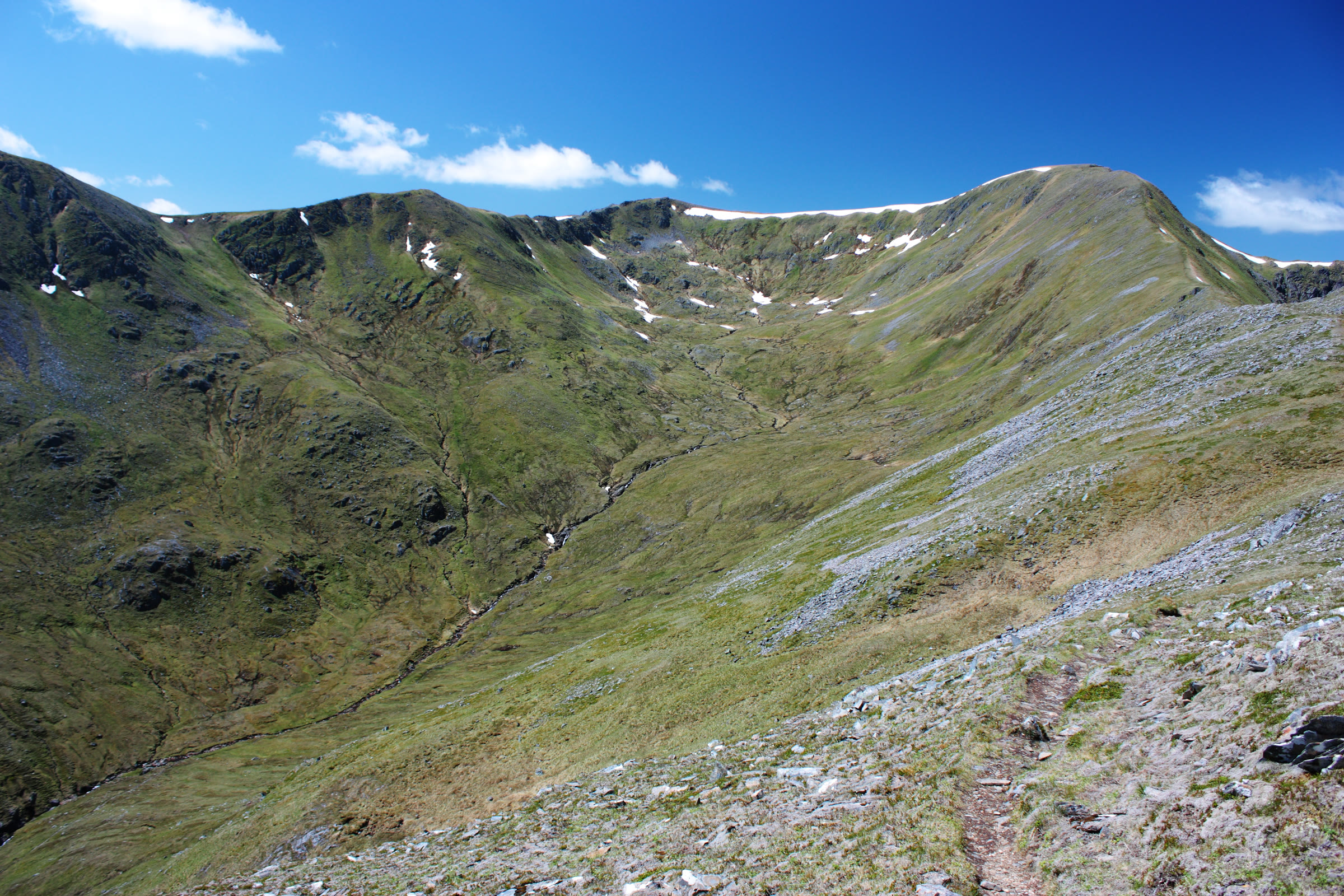 The ridge rising to the rounded summit of Màm Sodhail, late snow lying in the corrie.