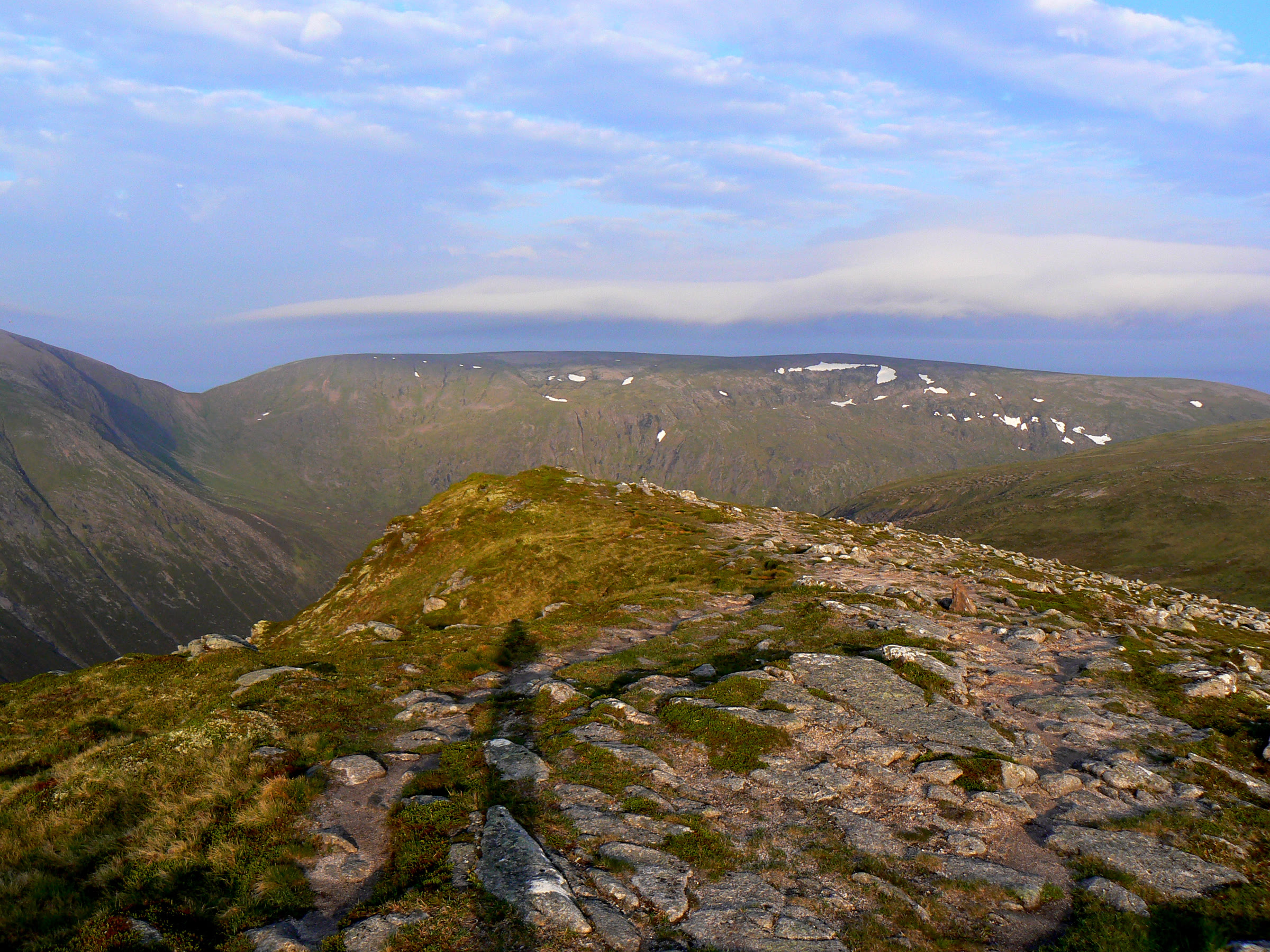 A band of cloud over the plateau of Monadh Mòr, a stony path in front.