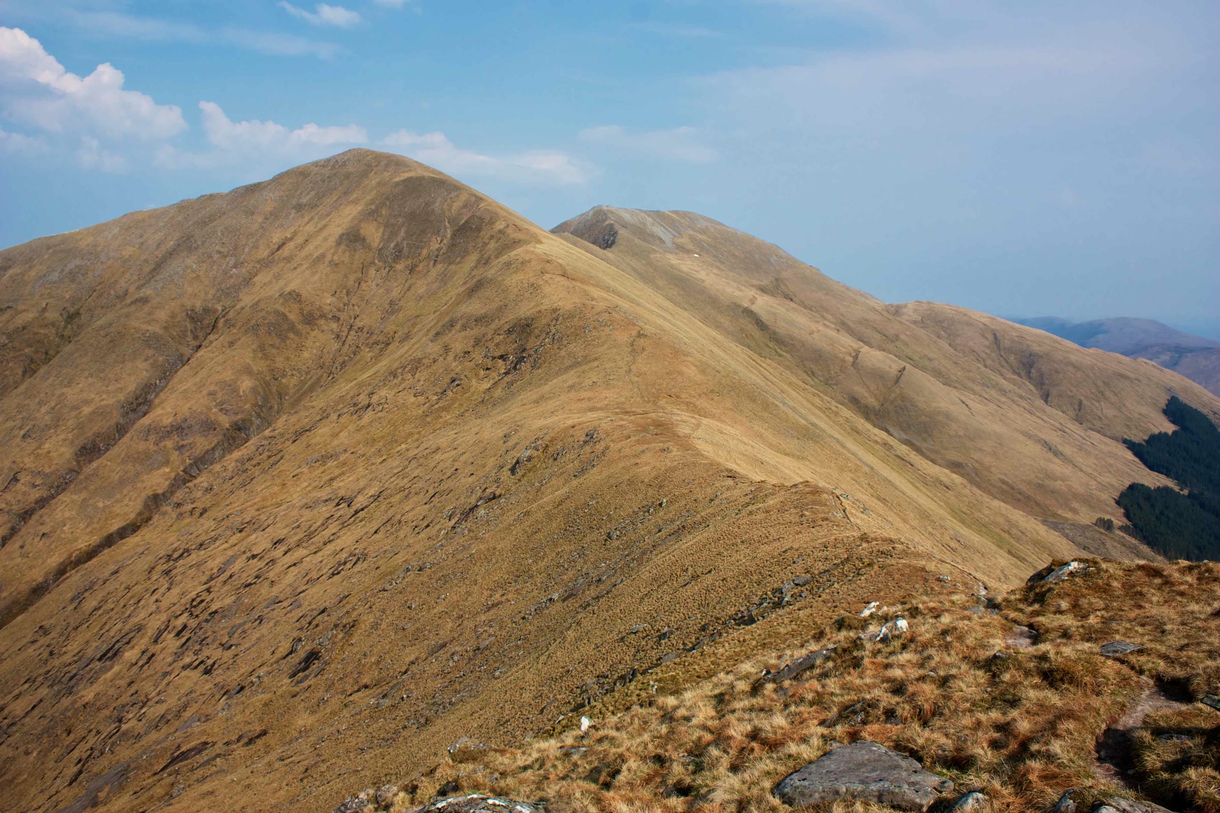 The broad grassy slopes of Saileag rising from Bealach na Lapain under a blue sky.