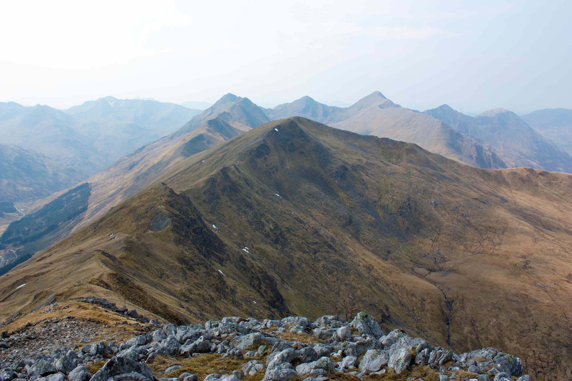 Saileag with the pointed tops of the Five Sisters of Kintail in haze beyond.