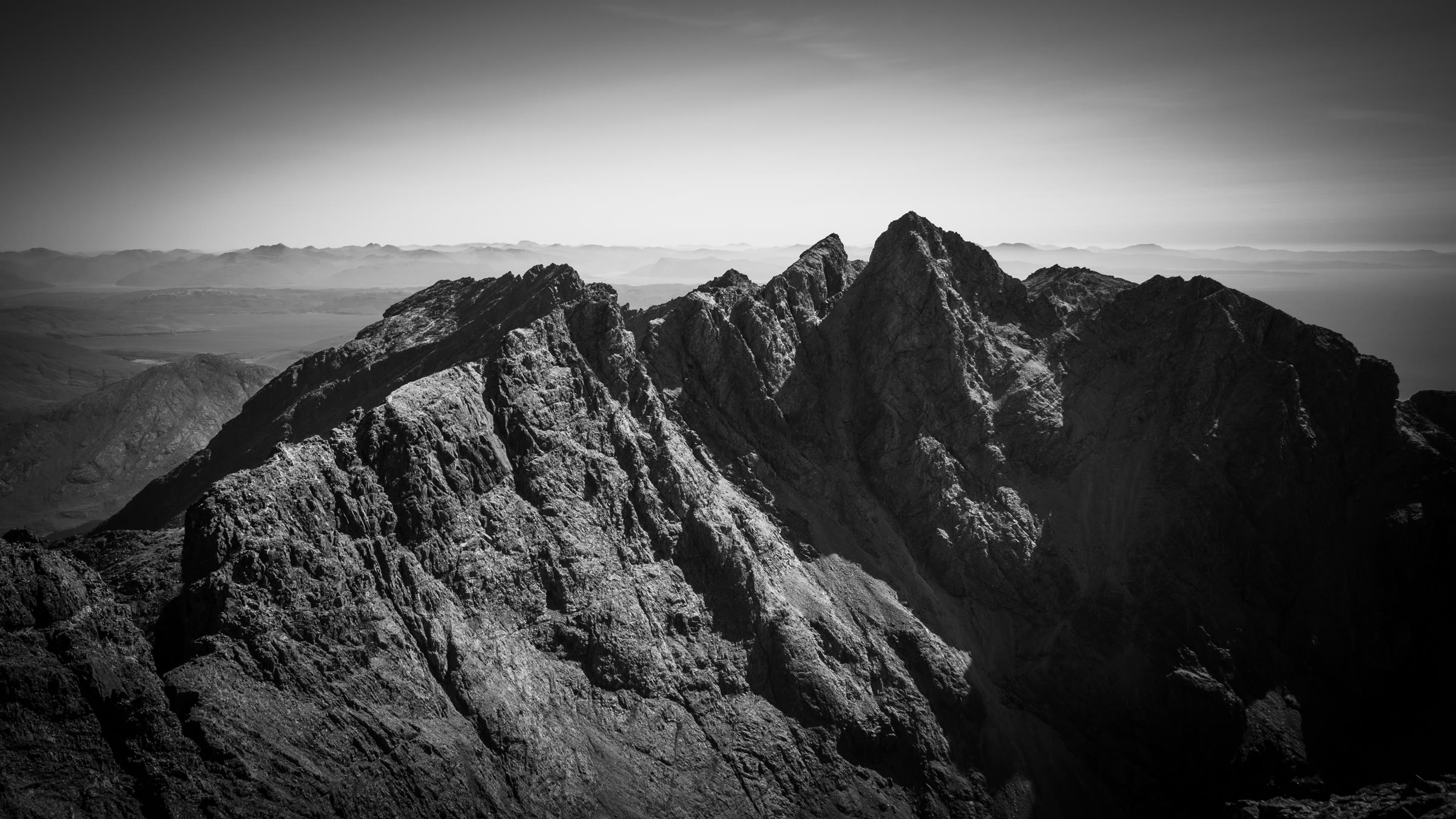 Sgùrr Alasdair and Sgùrr Mhic Choinnich, sharp rock peaks in black and white.