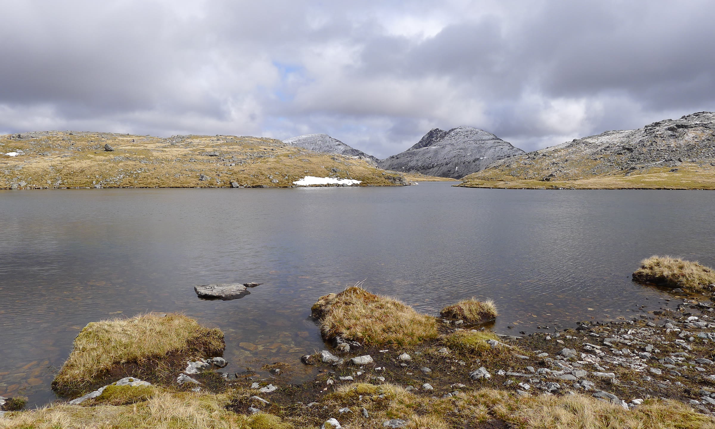 Sgùrr Choinnich beyond a hill lochan, its top frosted.