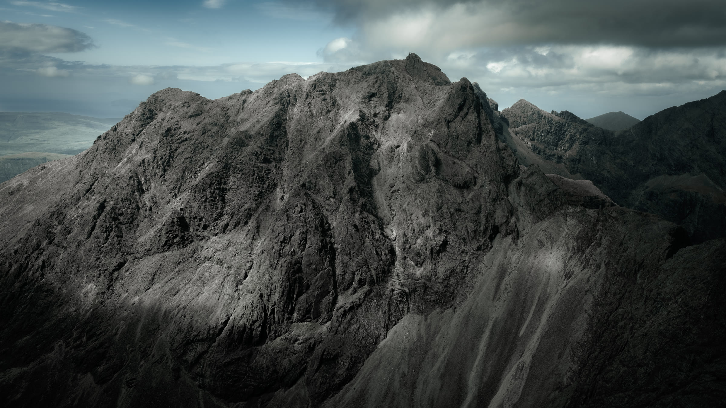 The dark rock face of Sgùrr Dearg, the Inaccessible Pinnacle a small fin on its crest.