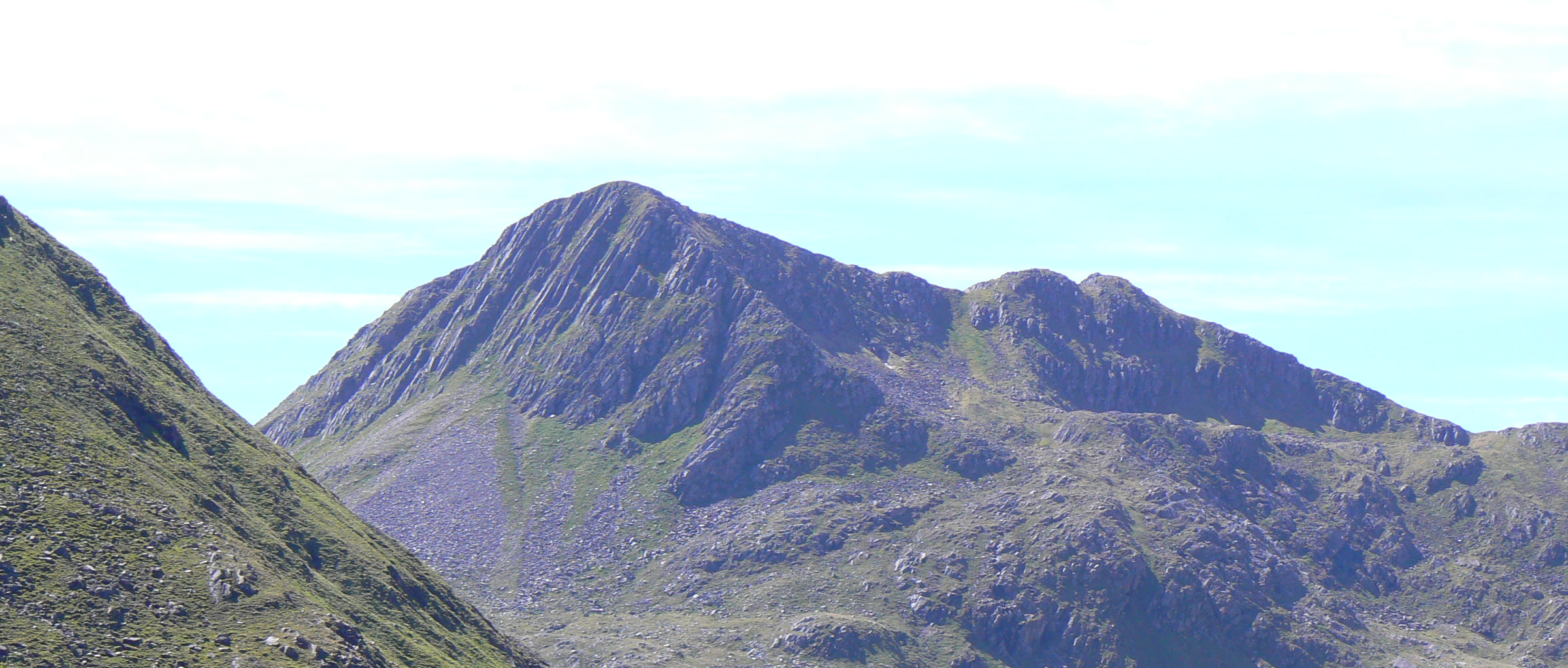 The craggy peak of Sgùrr na Sgìne at the head of a green glen.