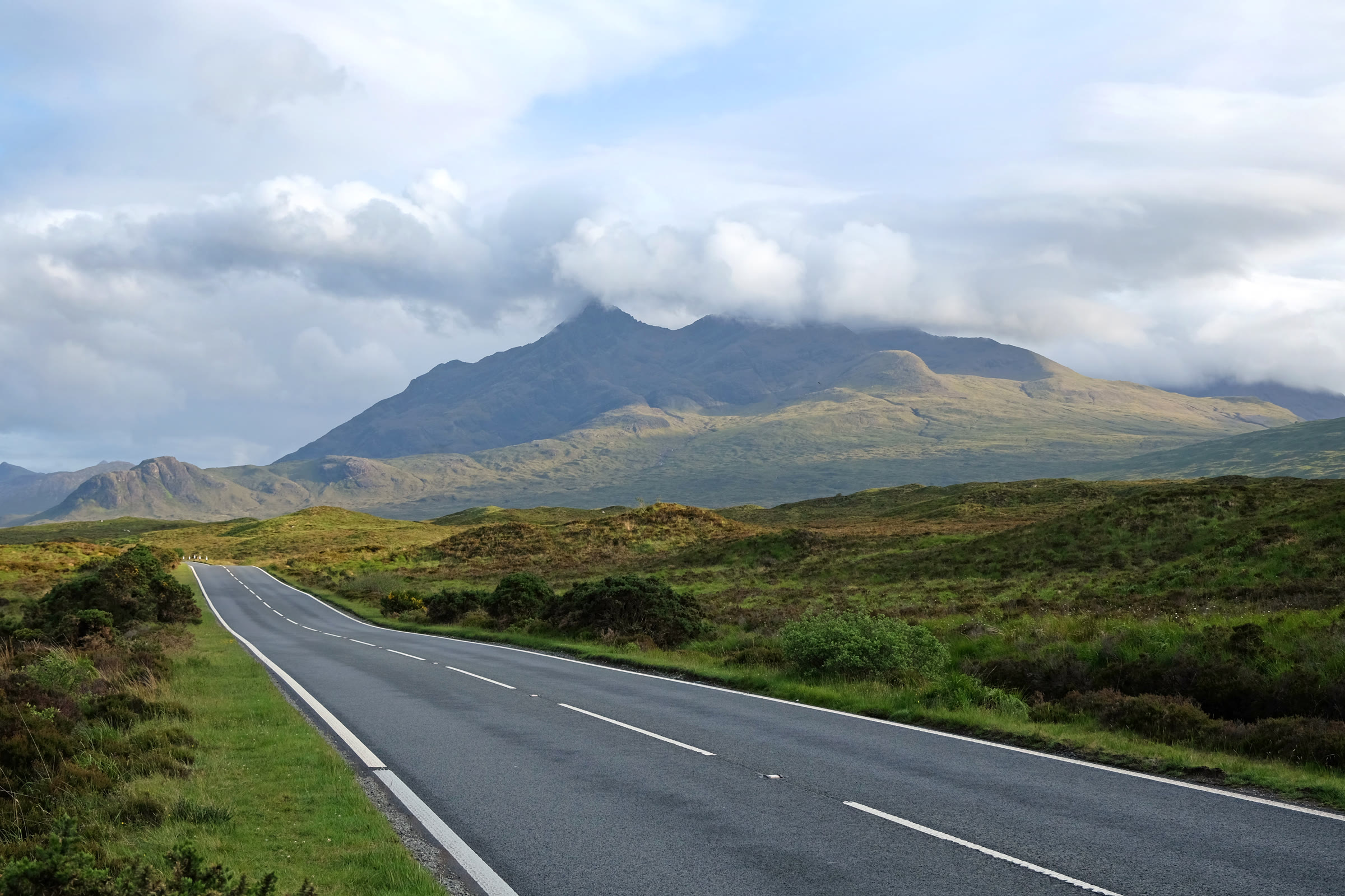 Sgùrr nan Gillean's peak showing beneath cloud, from the road across the moor.