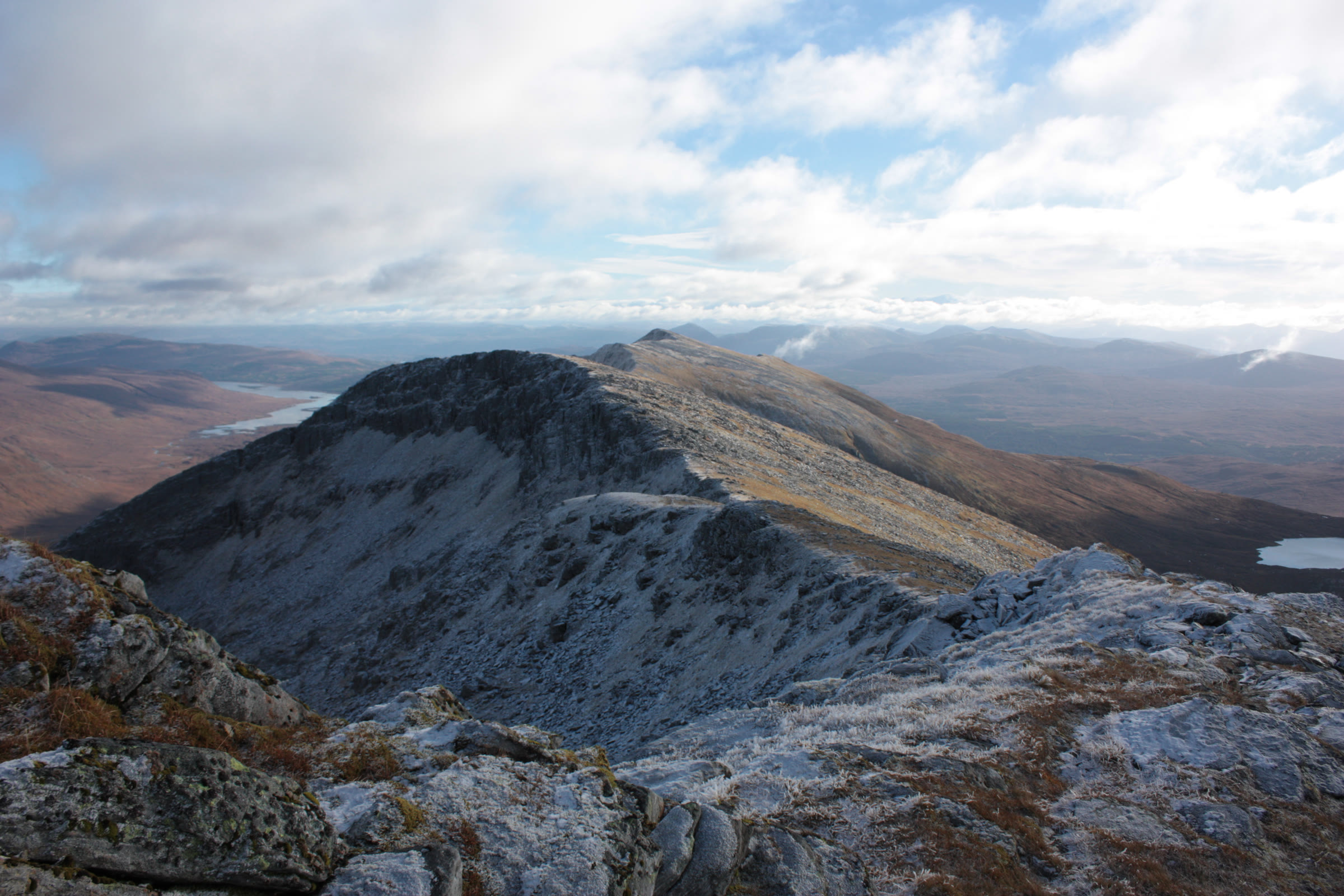 A frosted ridge running out towards Spidean Mialach, lochs and moorland beyond.