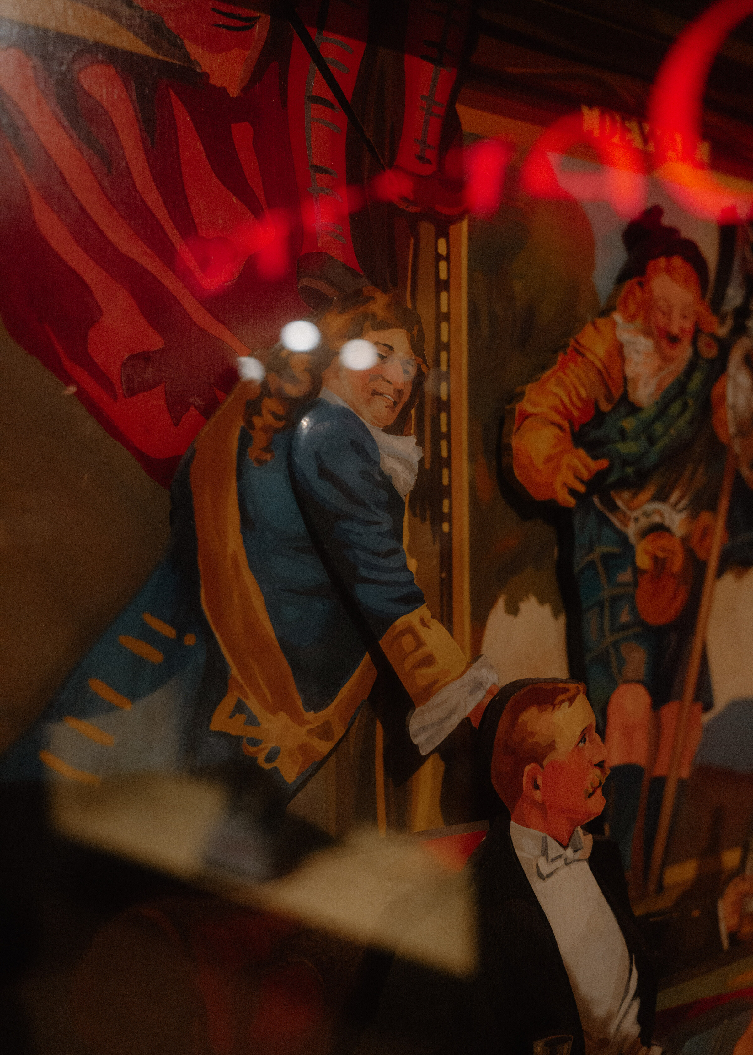 A detail of an old Dewar's advertising painting: a Highlander in a red bonnet and a gentleman in a powdered wig.