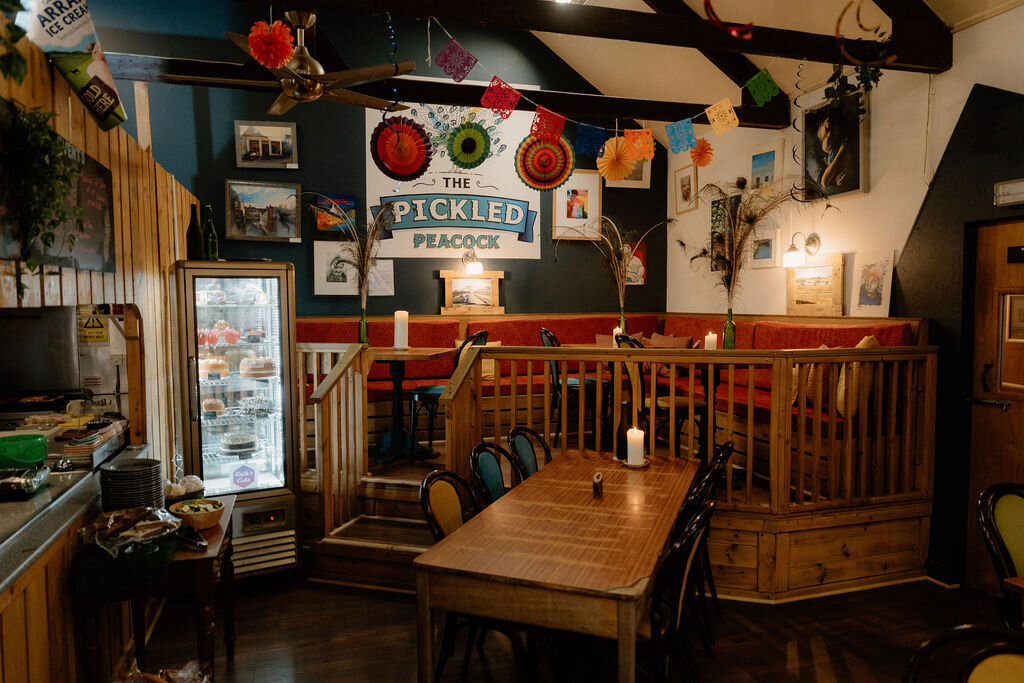 The Pickled Peacock's own sign hangs above a booth strung with bunting and fairy lights.