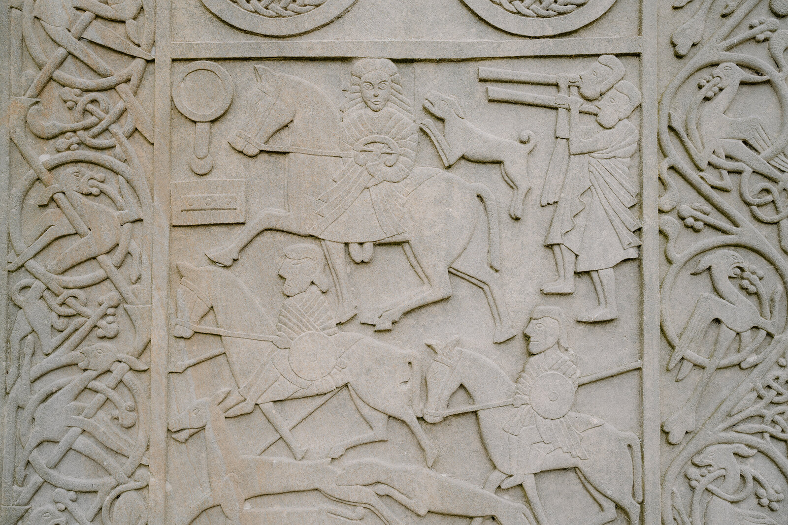 Riders and hunting scenes are carved into a Pictish-style standing stone on the Ross and Cromarty coast.