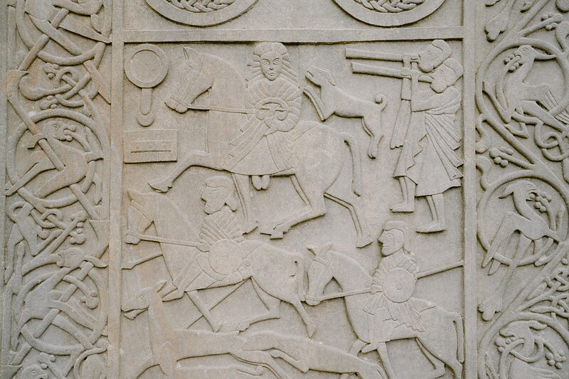 Riders and hunting scenes are carved into a Pictish-style standing stone on the Ross and Cromarty coast.