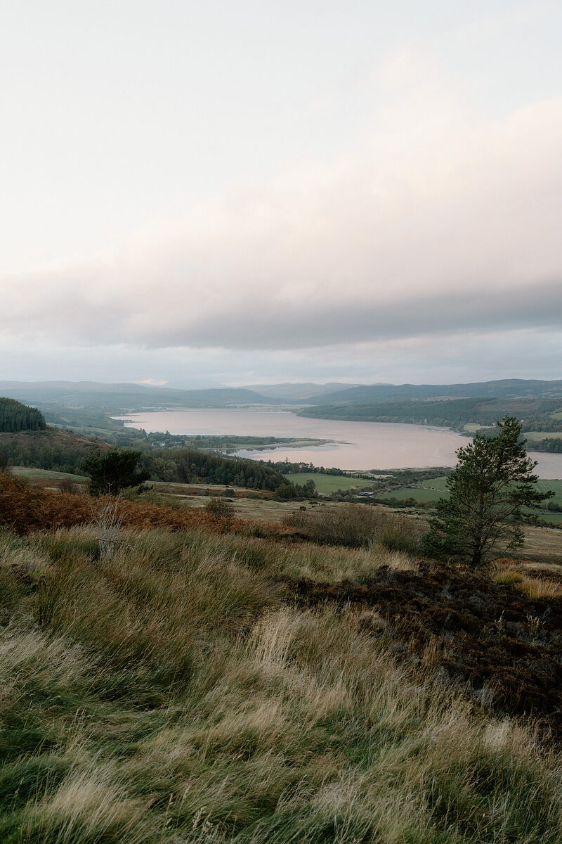 Heather-covered moorland slopes down to a wide estuary in Ross and Cromarty.
