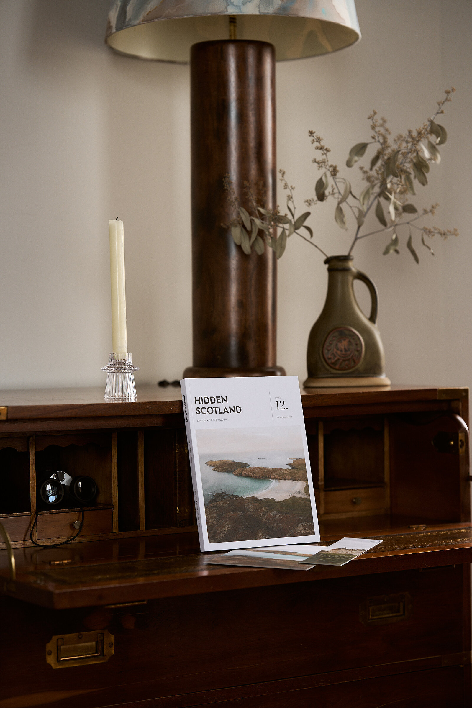 Issue 12 standing in an antique writing cabinet
