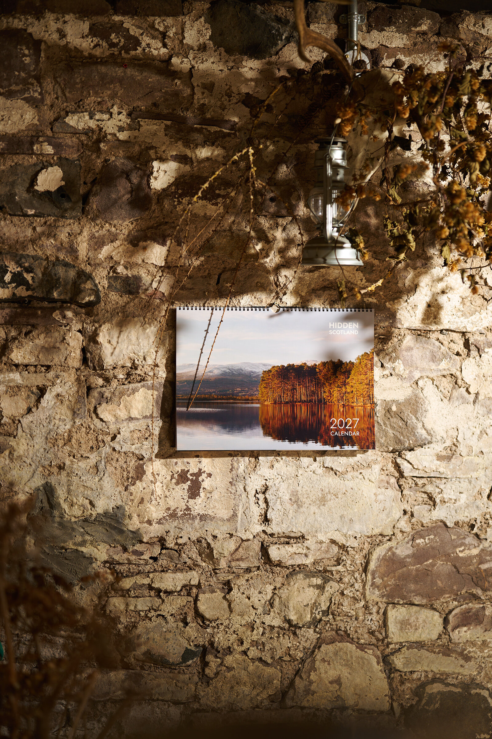 The 2027 calendar hanging on a whitewashed stone wall